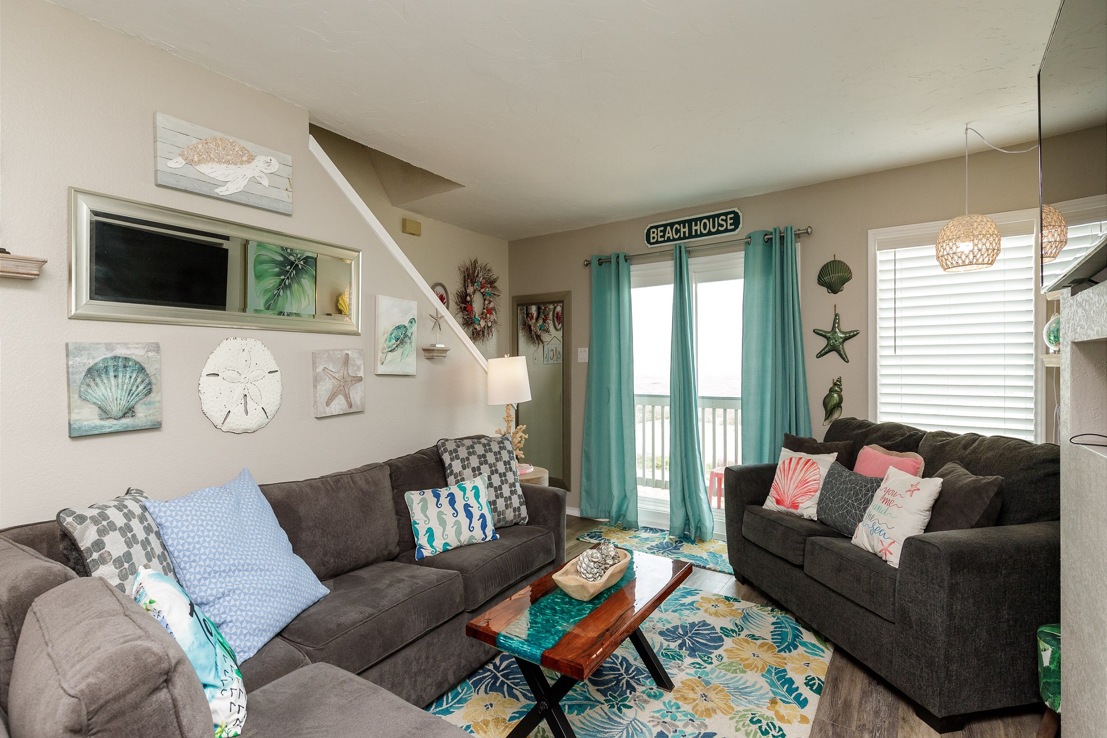 Lovely living area with private balcony over looking the beach 