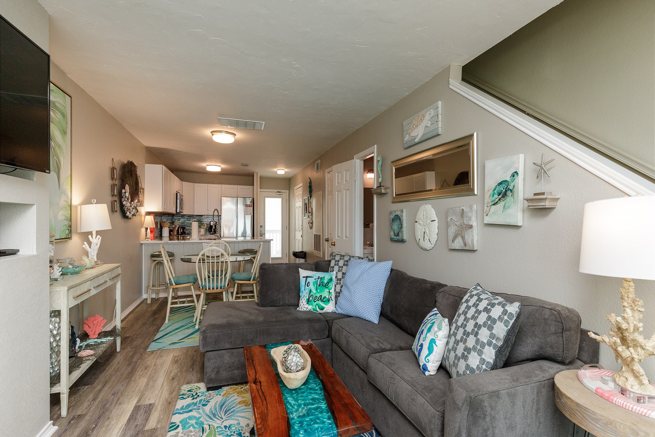 The kitchen, dining, and living areas blend seamlessly together for a bright and airy feel