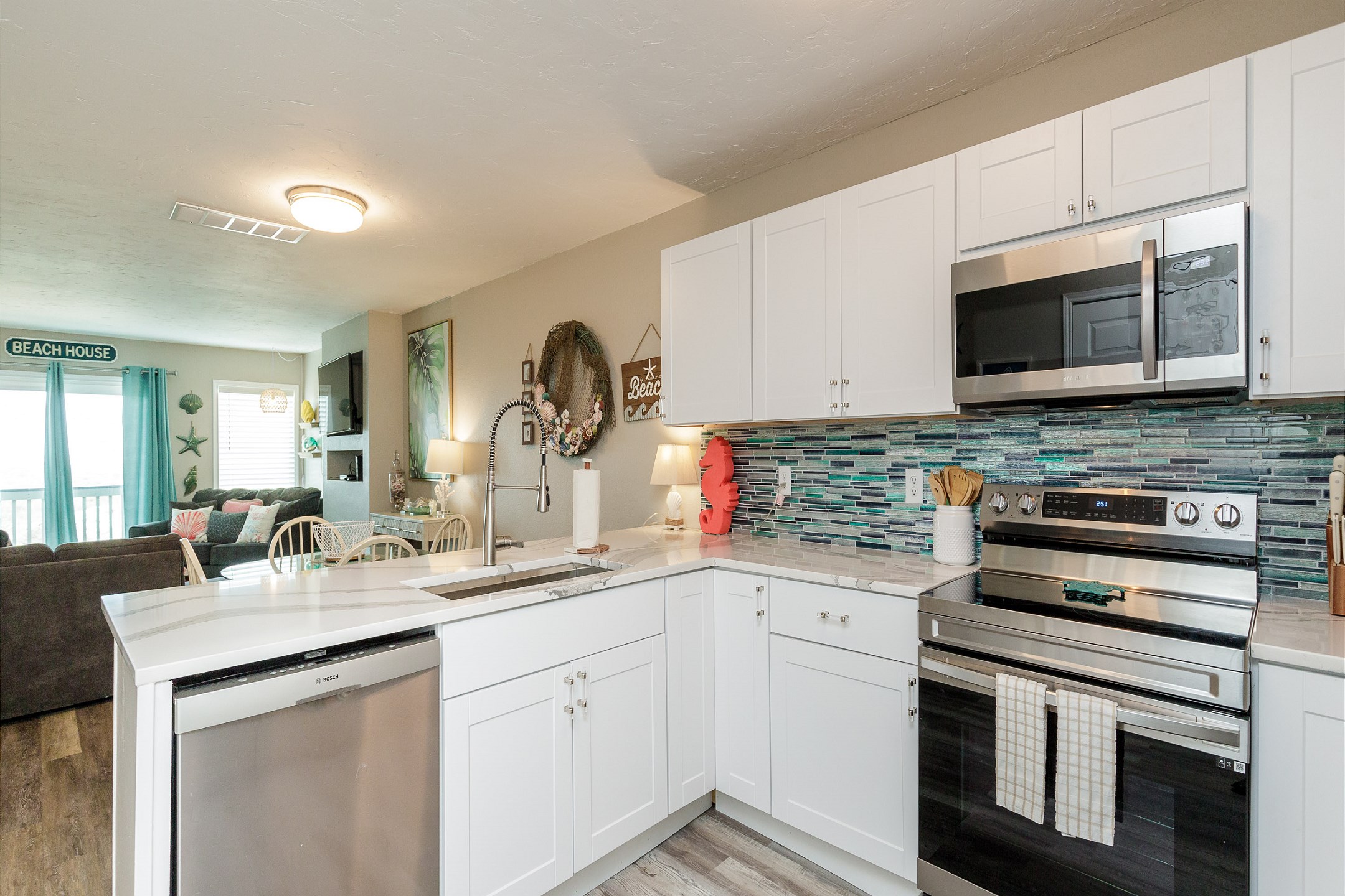 Fully equipped kitchen with stainless steel appliances and new tile backsplash 