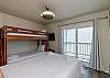 Guest bedroom with queen size bed, twin size bunk bed, and twin trundle, along with flat screen TV
