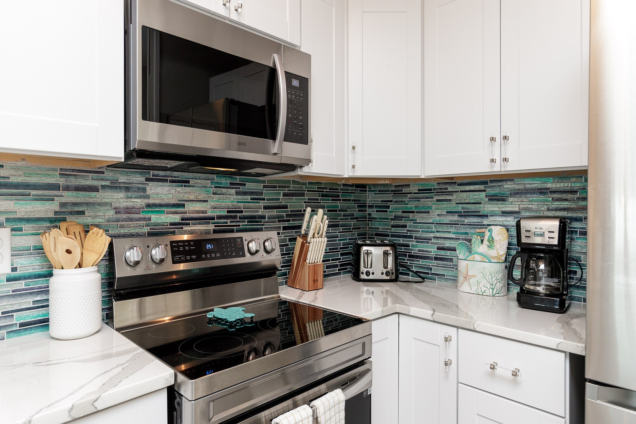 Coffee maker, toaster, cookware, dinnerware, and other kitchen essentials provided