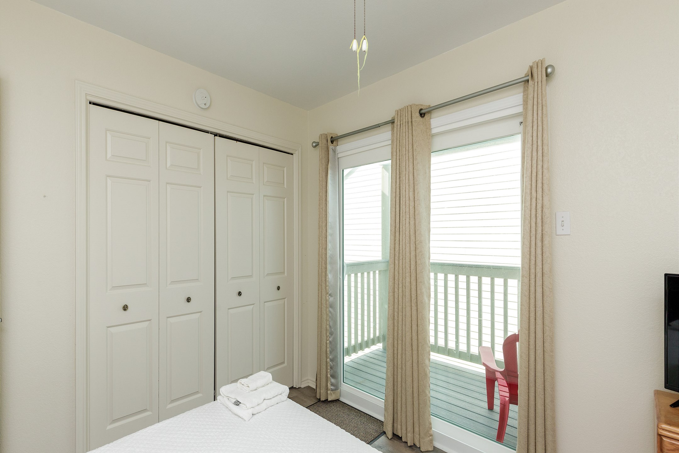 Second floor second bedroom with full and twin size beds and a private balcony 