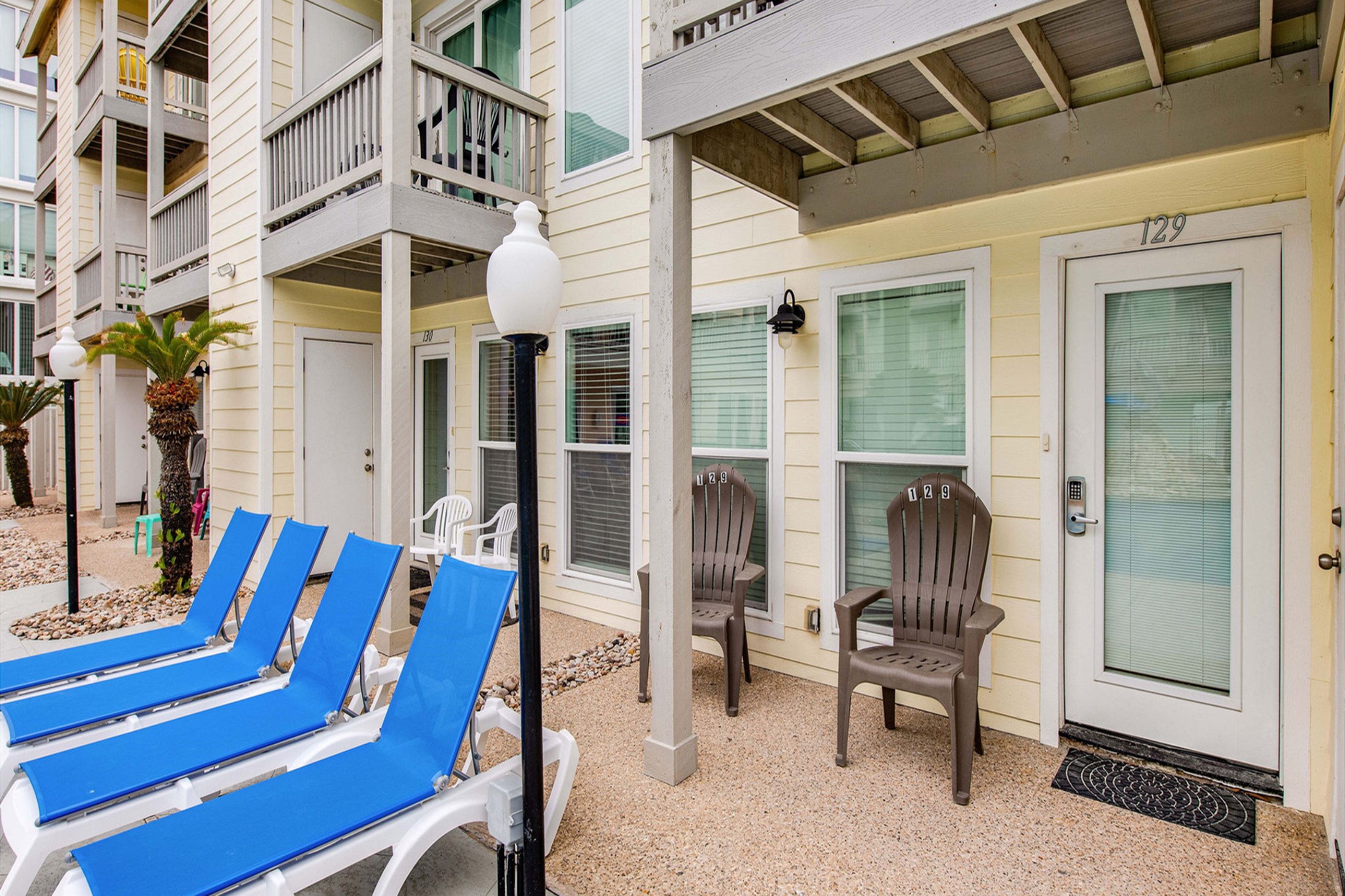 Front entrance to property with chairs and a view of the pool