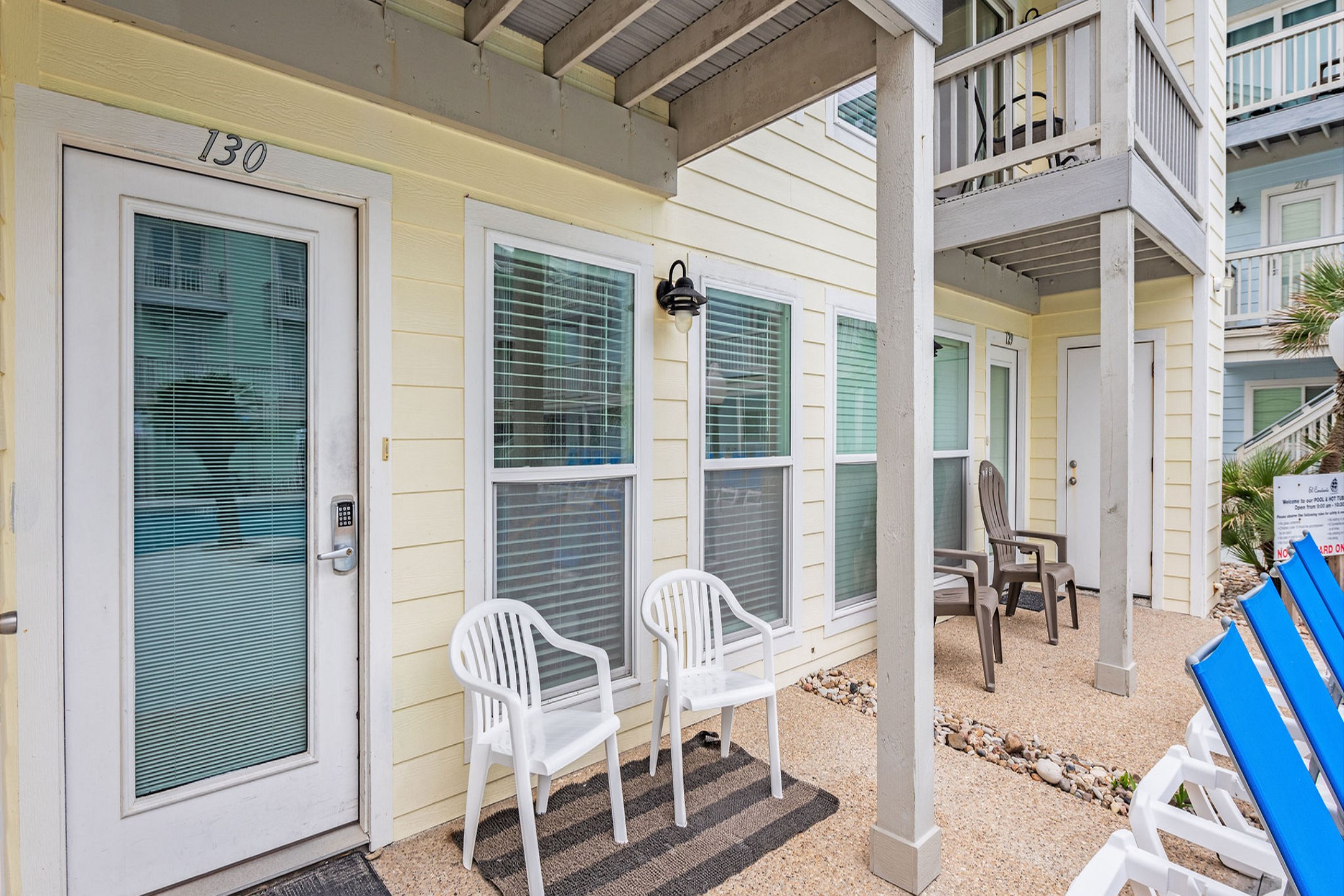 Front entrance to property with chairs and view of the pool