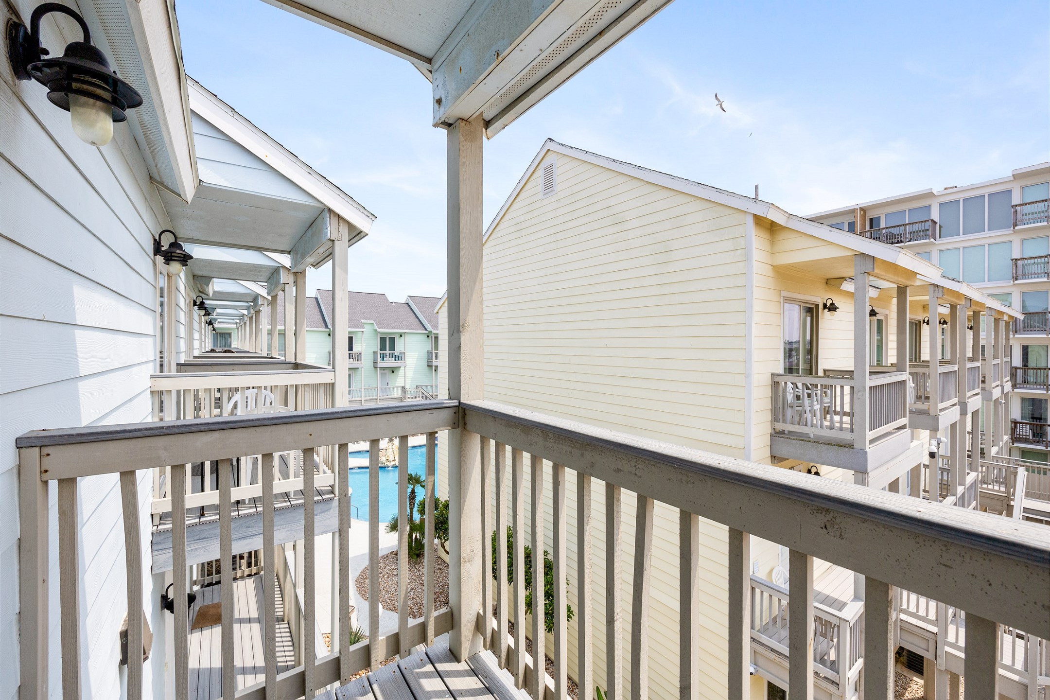 Second floor guest bedroom balcony with partial pool views