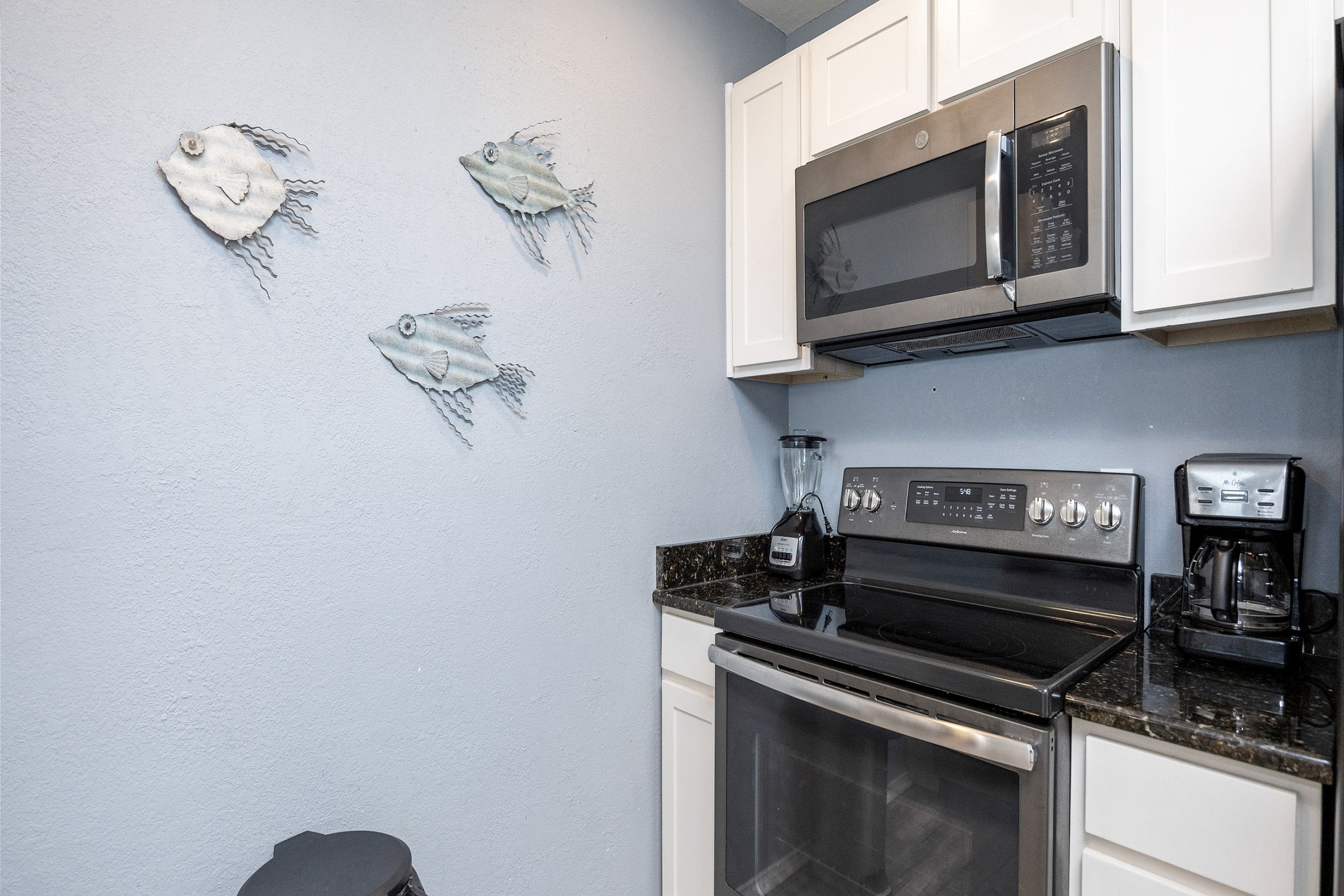 Coffee maker, toaster, cookware, dinnerware, and other kitchen essentials provided