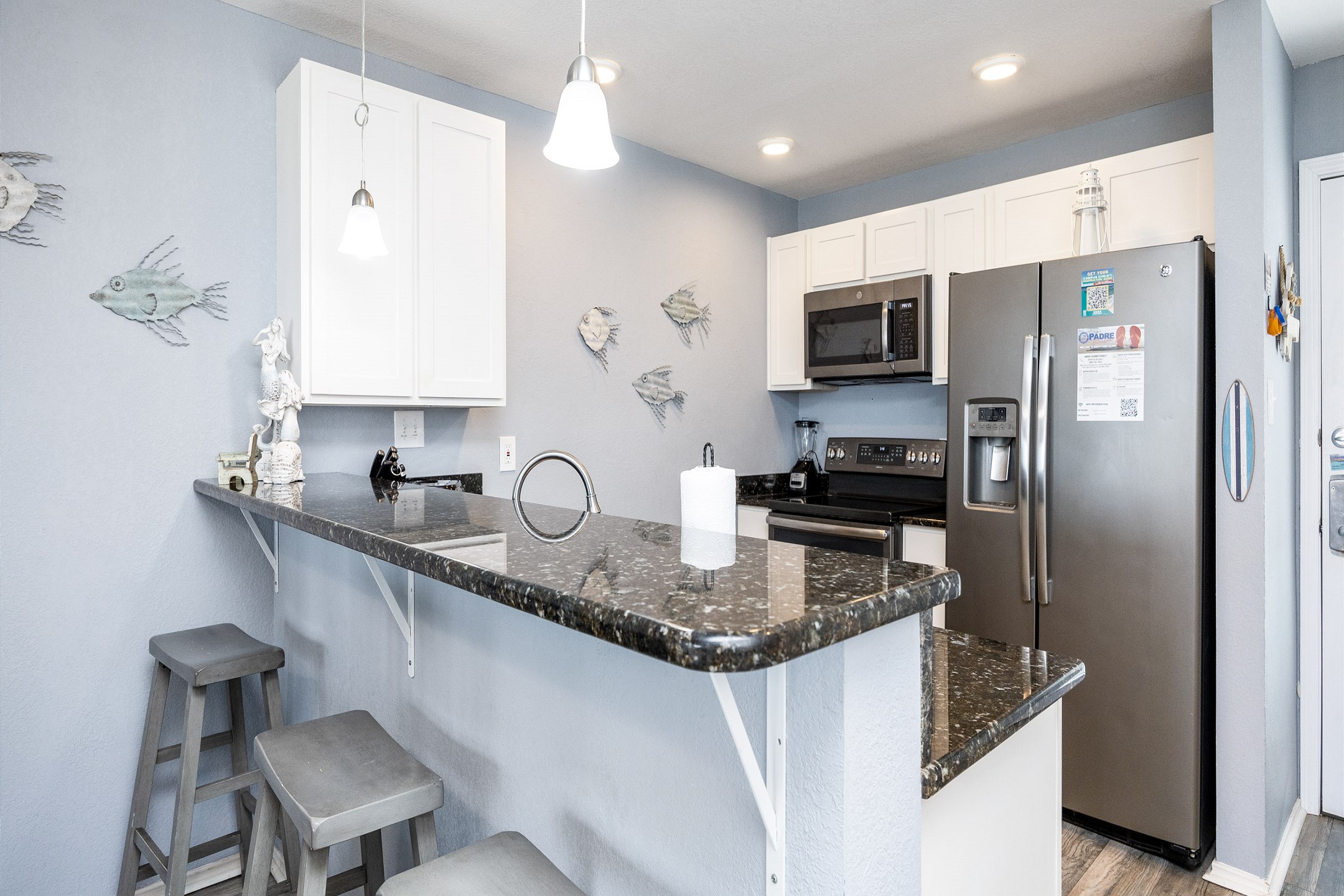 Well-equipped kitchen with modern appliances and breakfast bar 