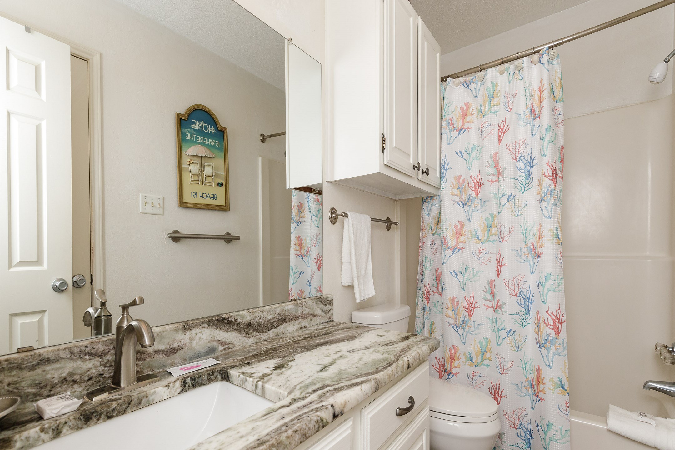 Guest bathroom with tub and shower 
