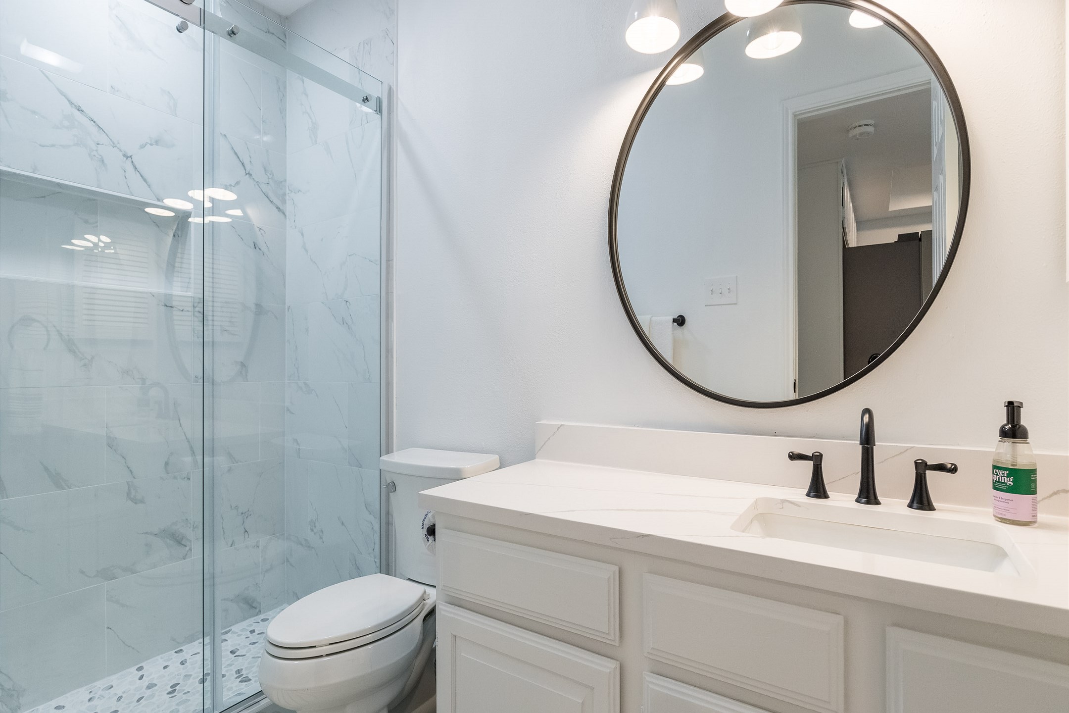 Newly updated guest bathroom with a sleek walk-in shower