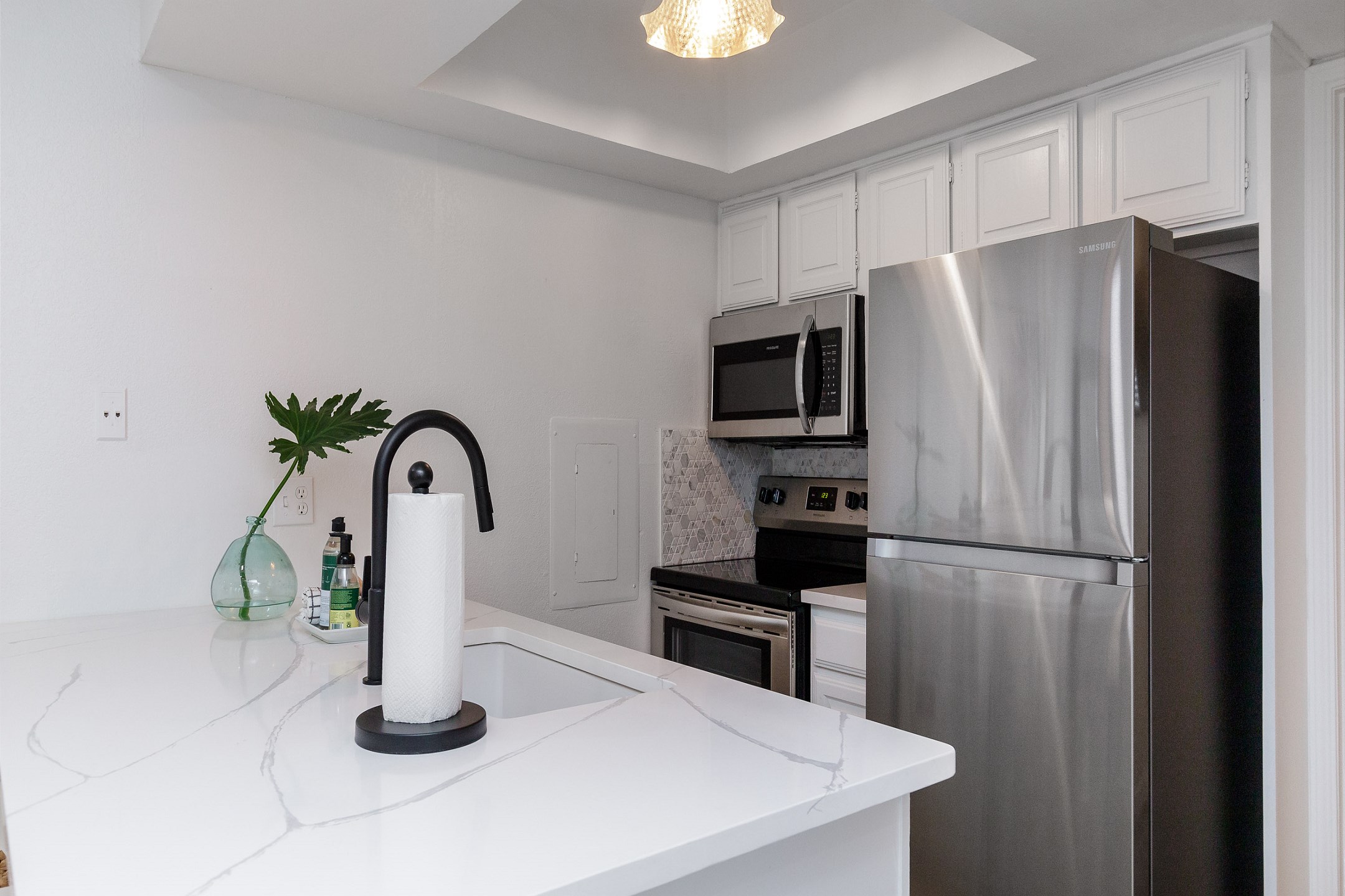 Fully equipped kitchen area with new stainless steel appliances and upgraded counters and cabinets 