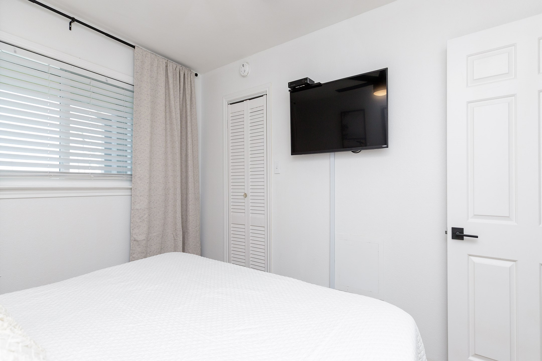 Master bedroom with king size bed and flat screen TV