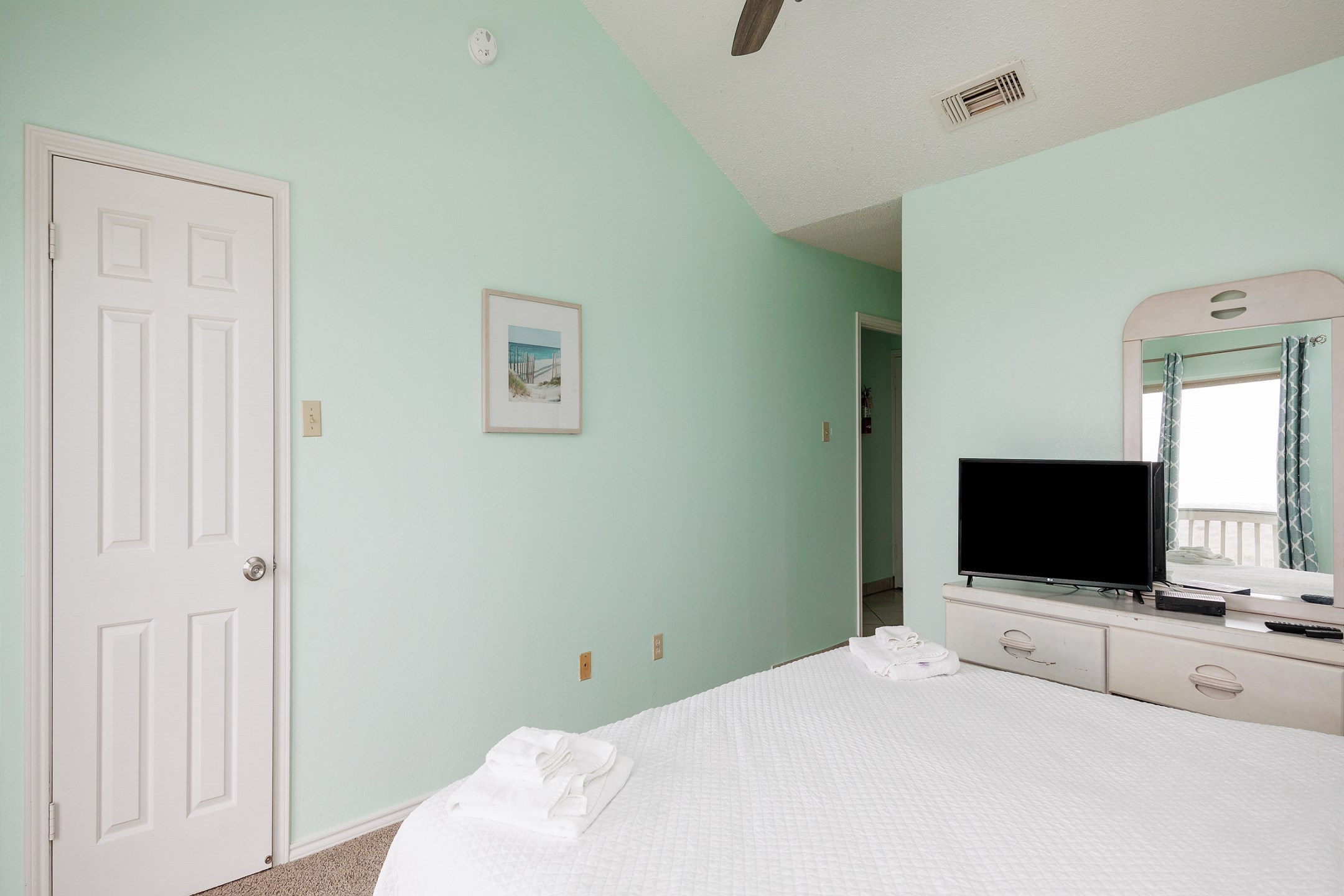 Master bedroom on the second floor with king size bed, private balcony, and ensuite bathroom