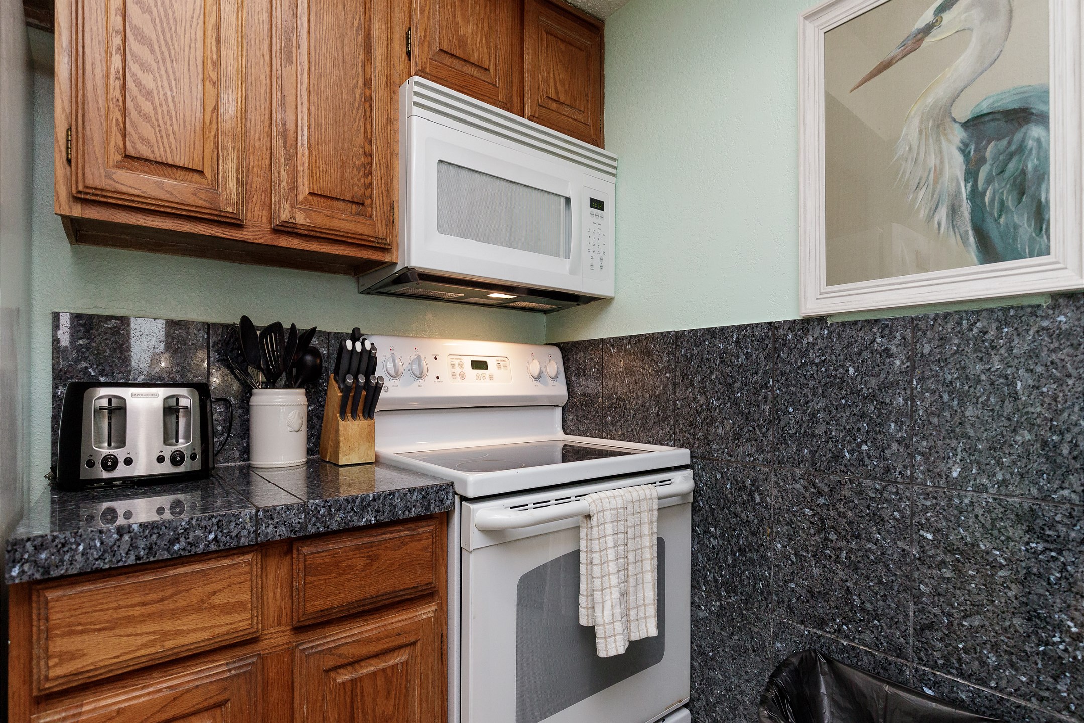 Coffee maker, toaster, dinnerware, and other essentials provided