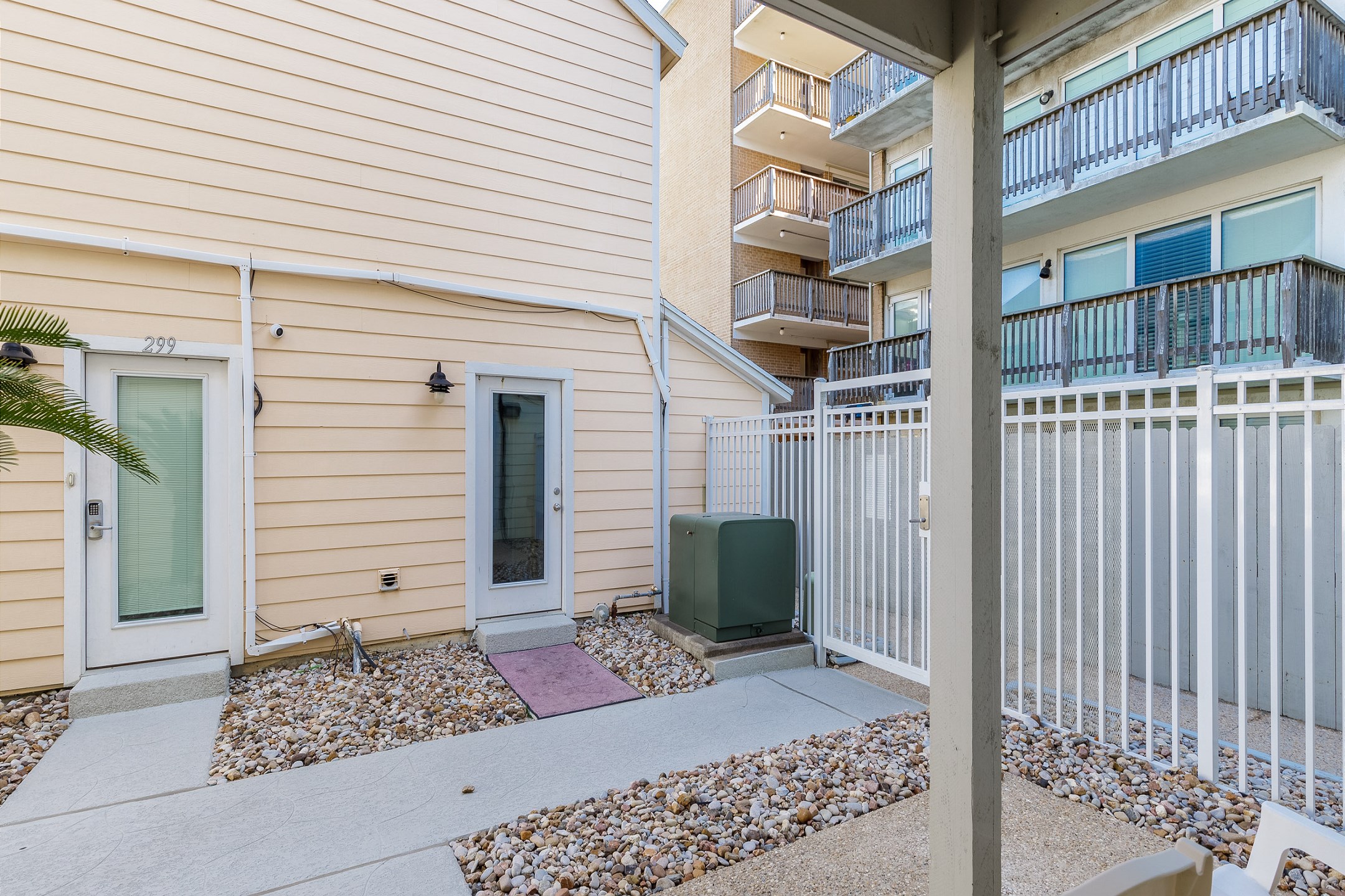 Corner condo with a private patio, offering the perfect spot for easy pool and beach access