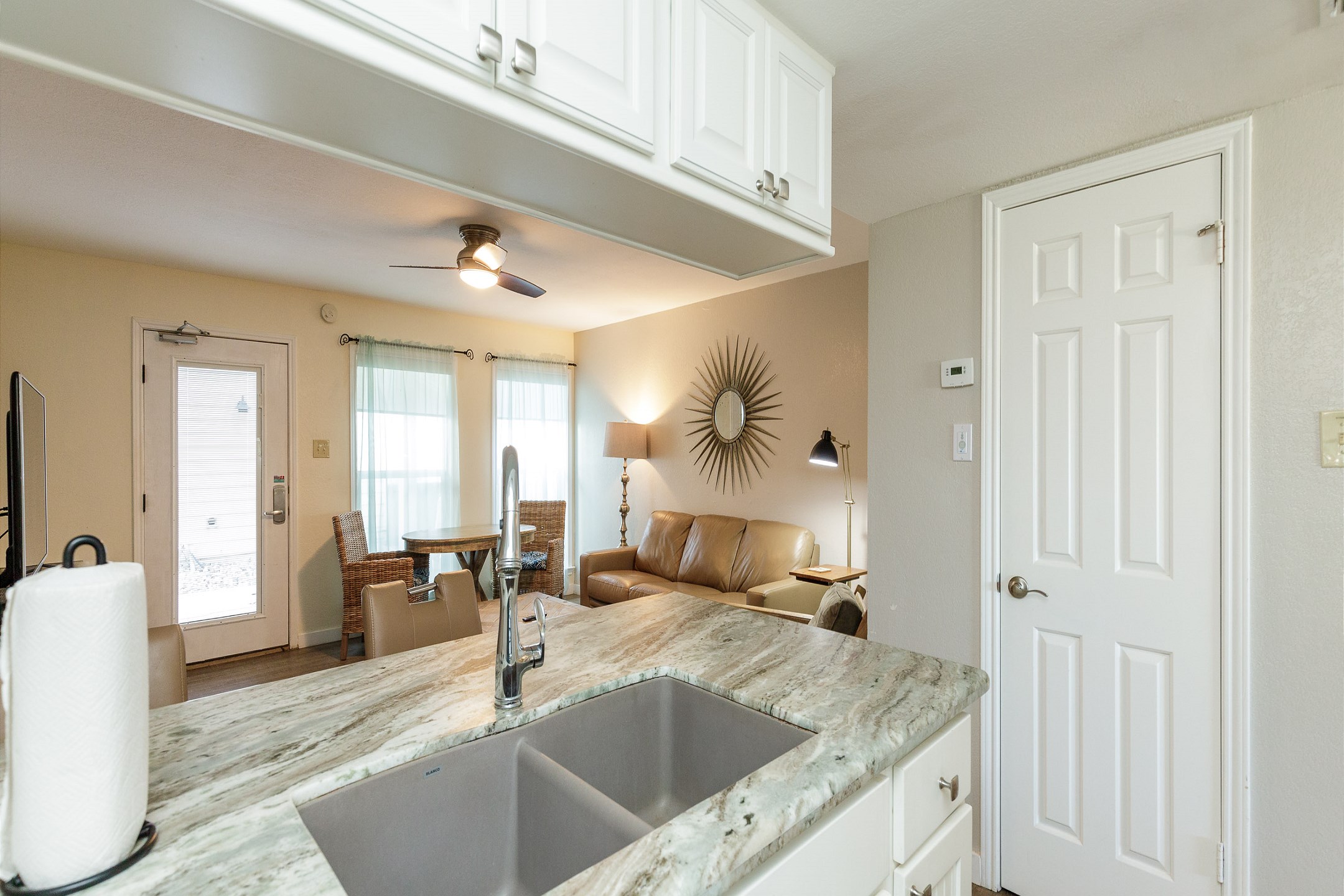 Bright and airy kitchen with natural light over looking into the living area