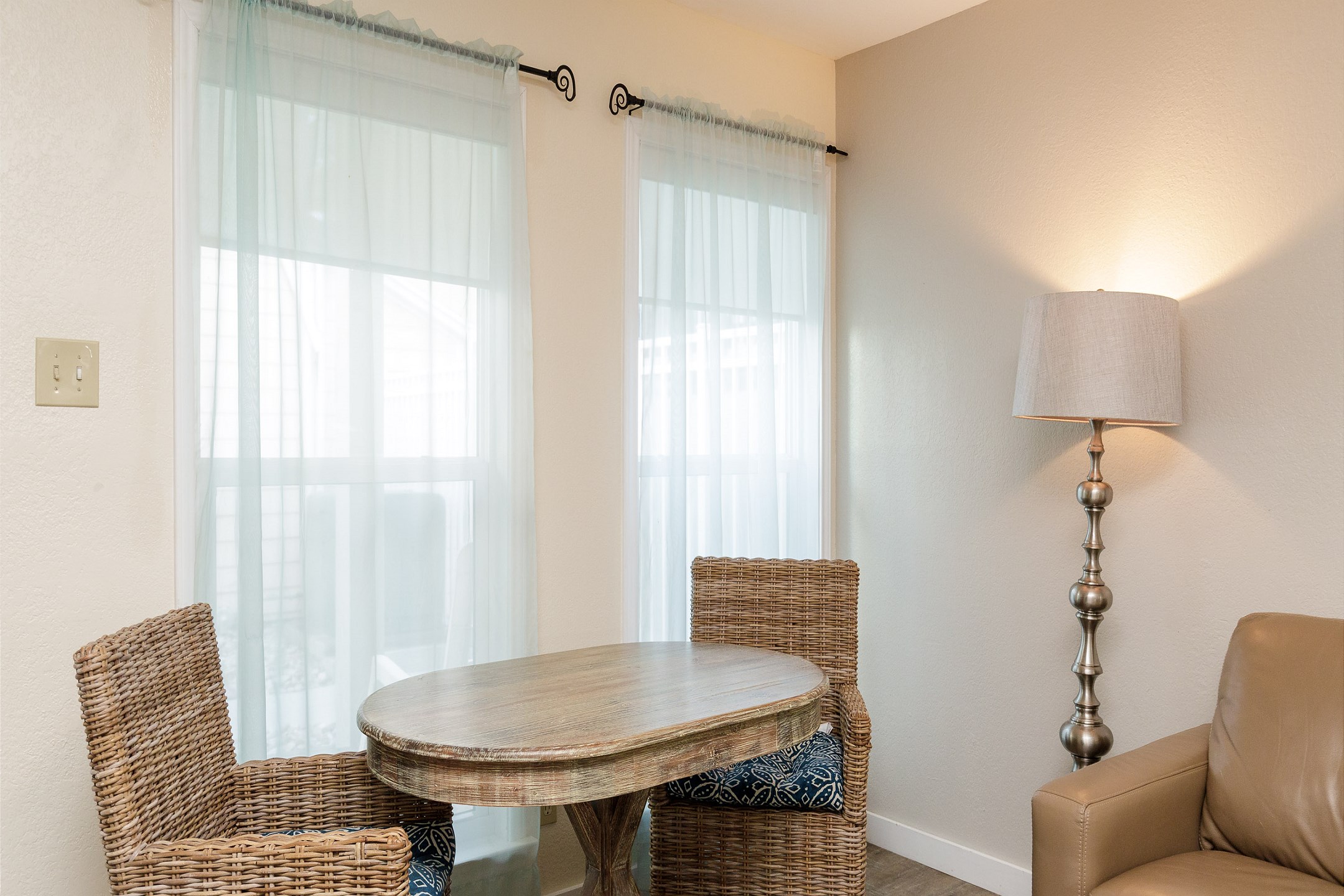 Charming seating area by the window, perfect for relaxing and sharing a meal 