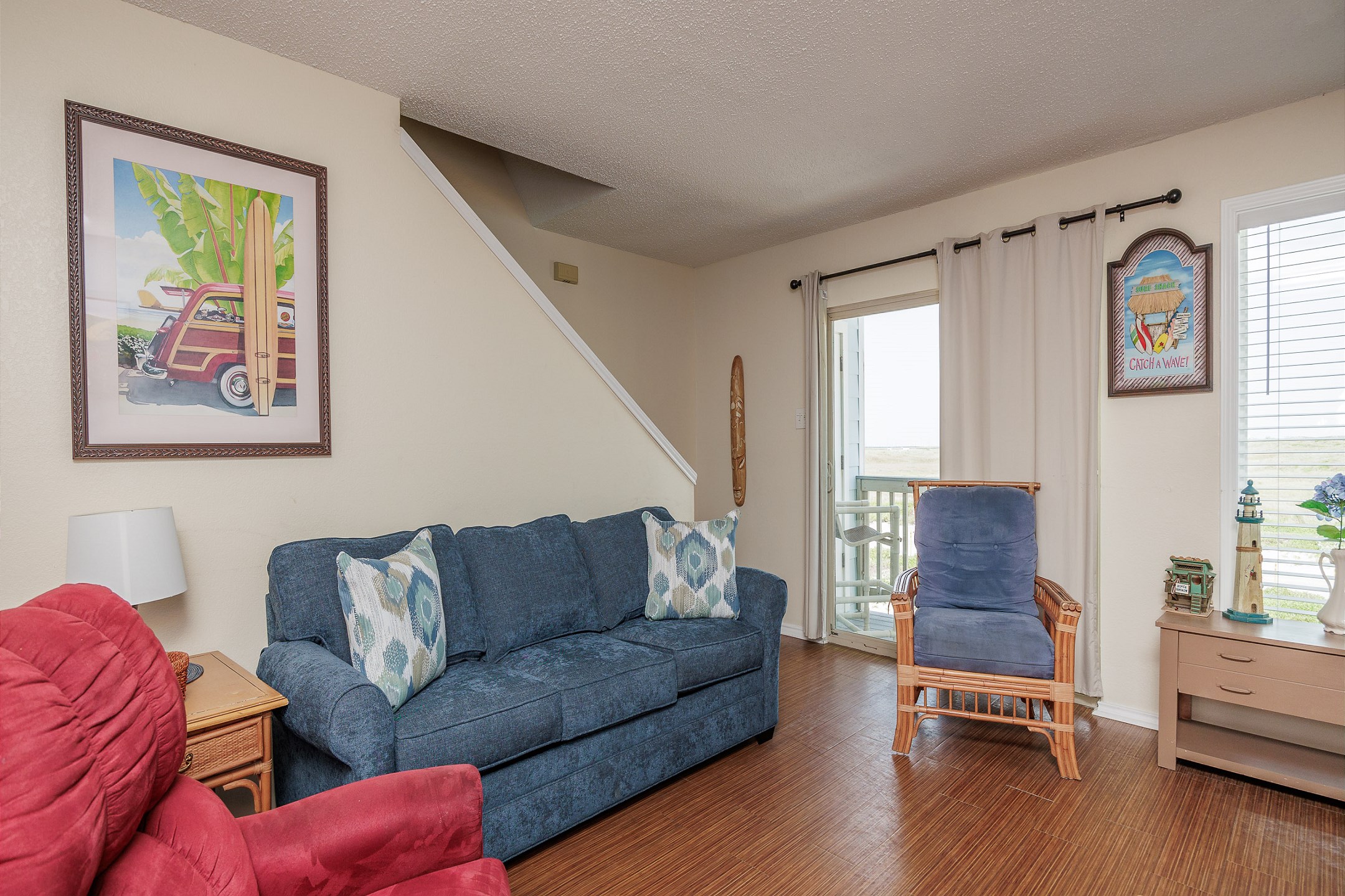 Coastal living area with cozy furnishings and private balcony 