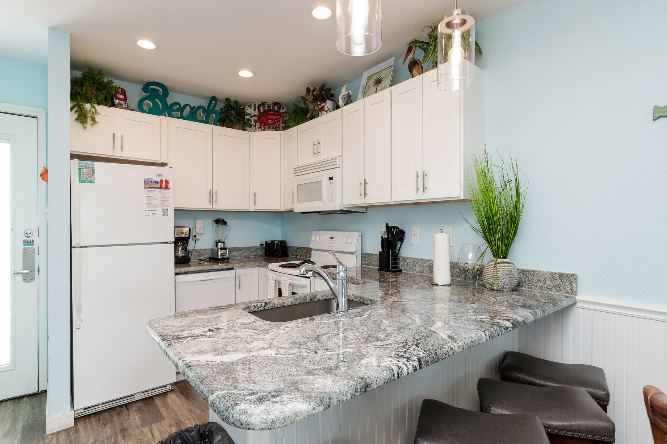 Fully equipped kitchen with beautiful counter tops and breakfast bar that seats four 