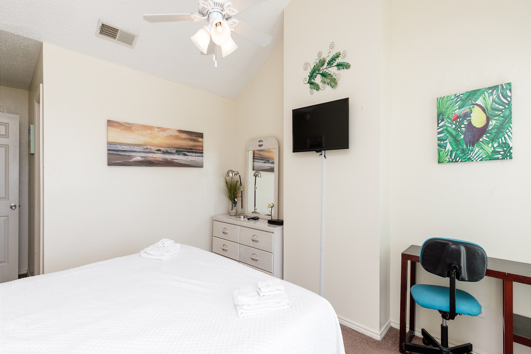 Master bedroom on second floor with king size bed, flat screen TV and private balcony 
