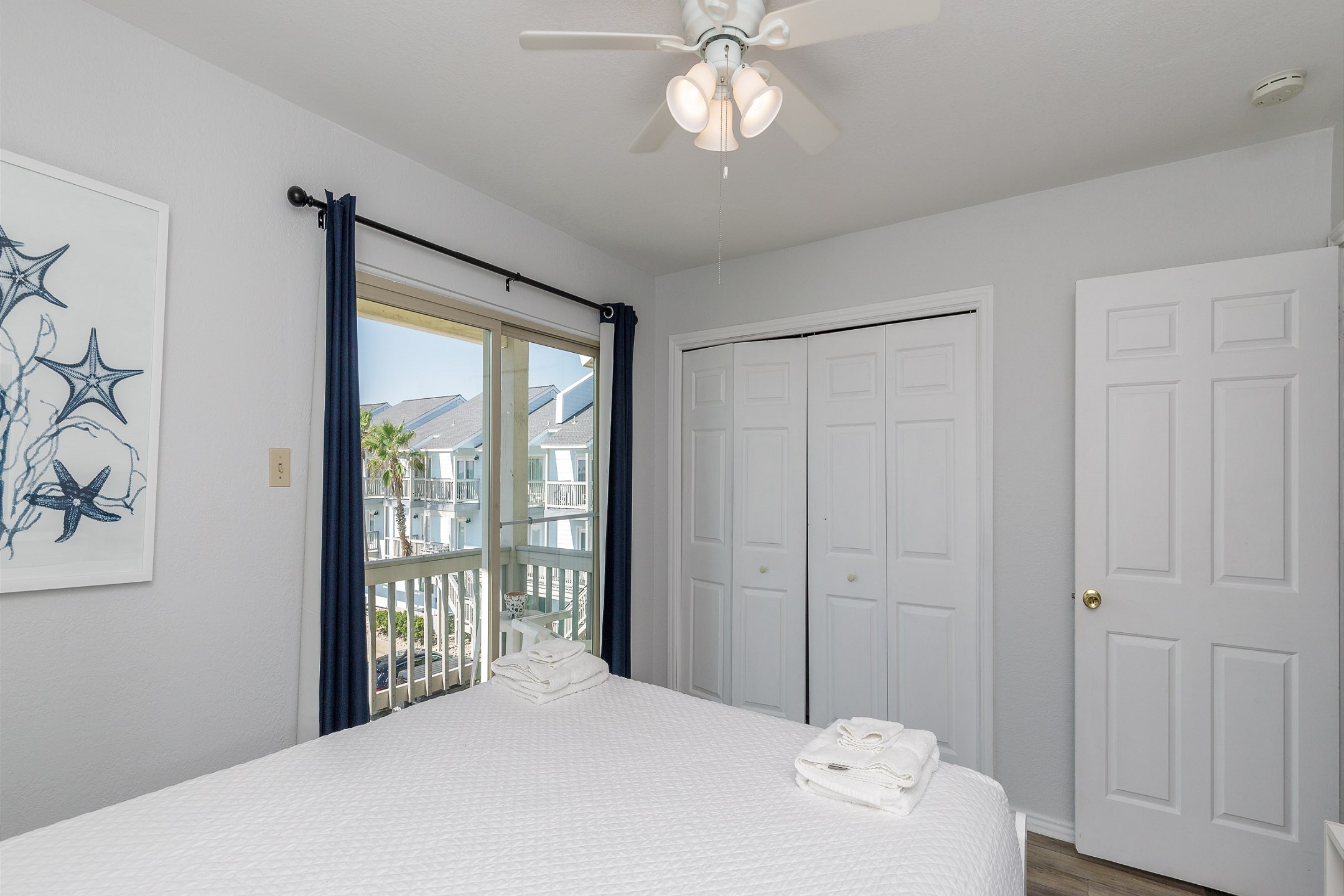 Second bedroom on the second floor with queen size bed, private balcony and flat screen TV