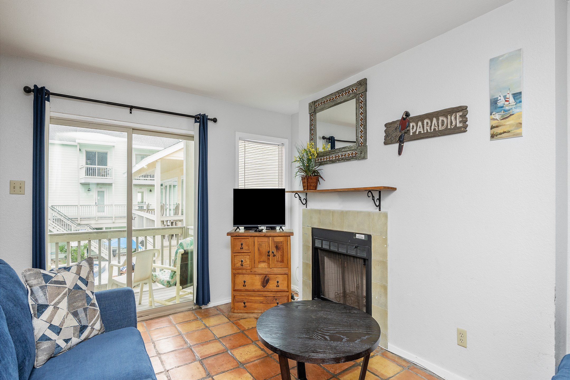 Open concept living area with queen size sleeper sofa and flat screen TV 