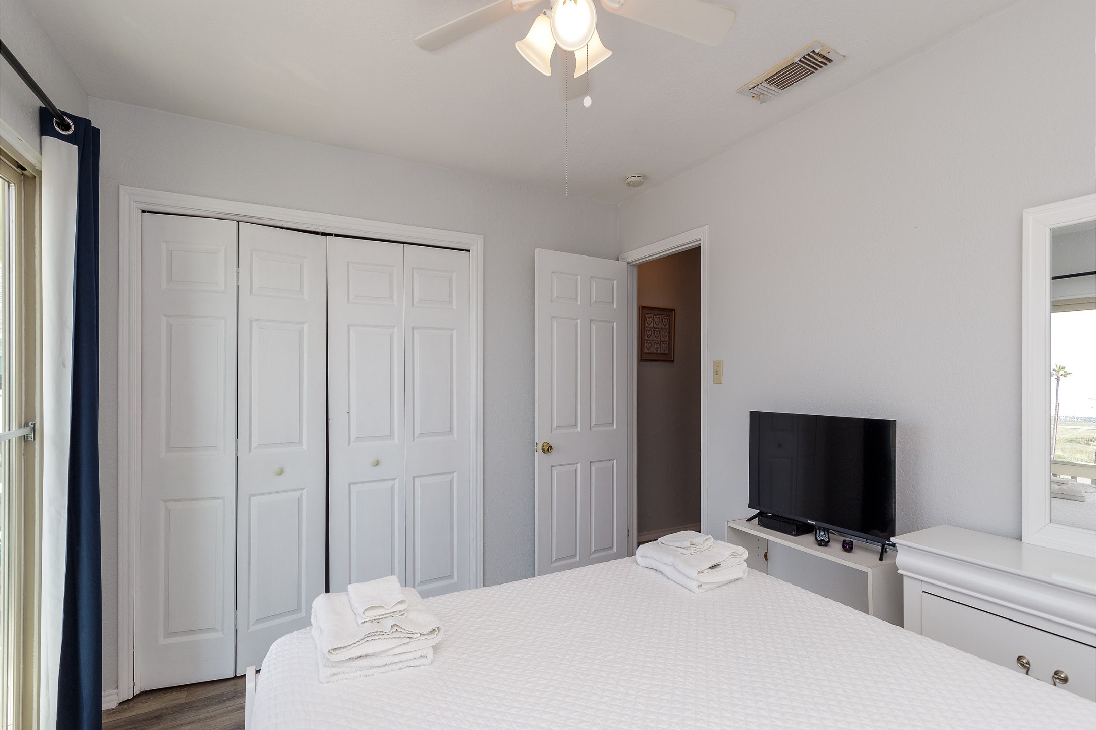Second bedroom on the second floor with queen size bed, private balcony and flat screen TV