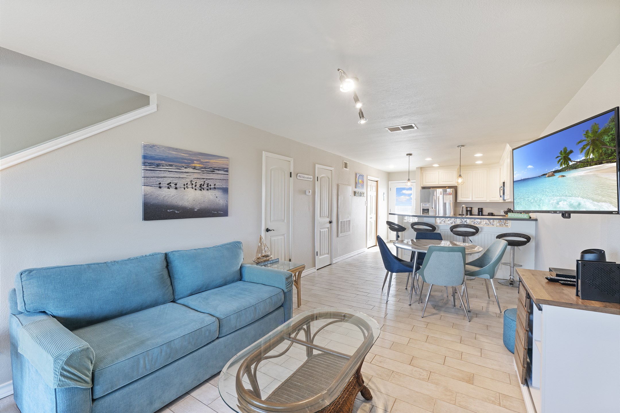 Open concept living, dining, and kitchen area with full size sleeper sofa that blends seamlessly 