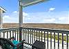 Private balcony off the master bedroom with chairs and dune view