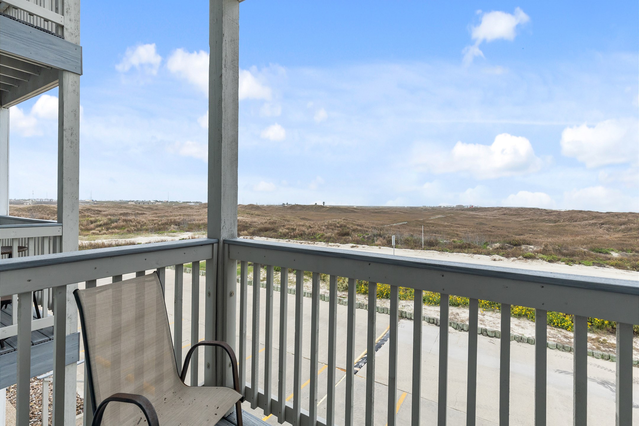 Private balcony off the living space with chairs 