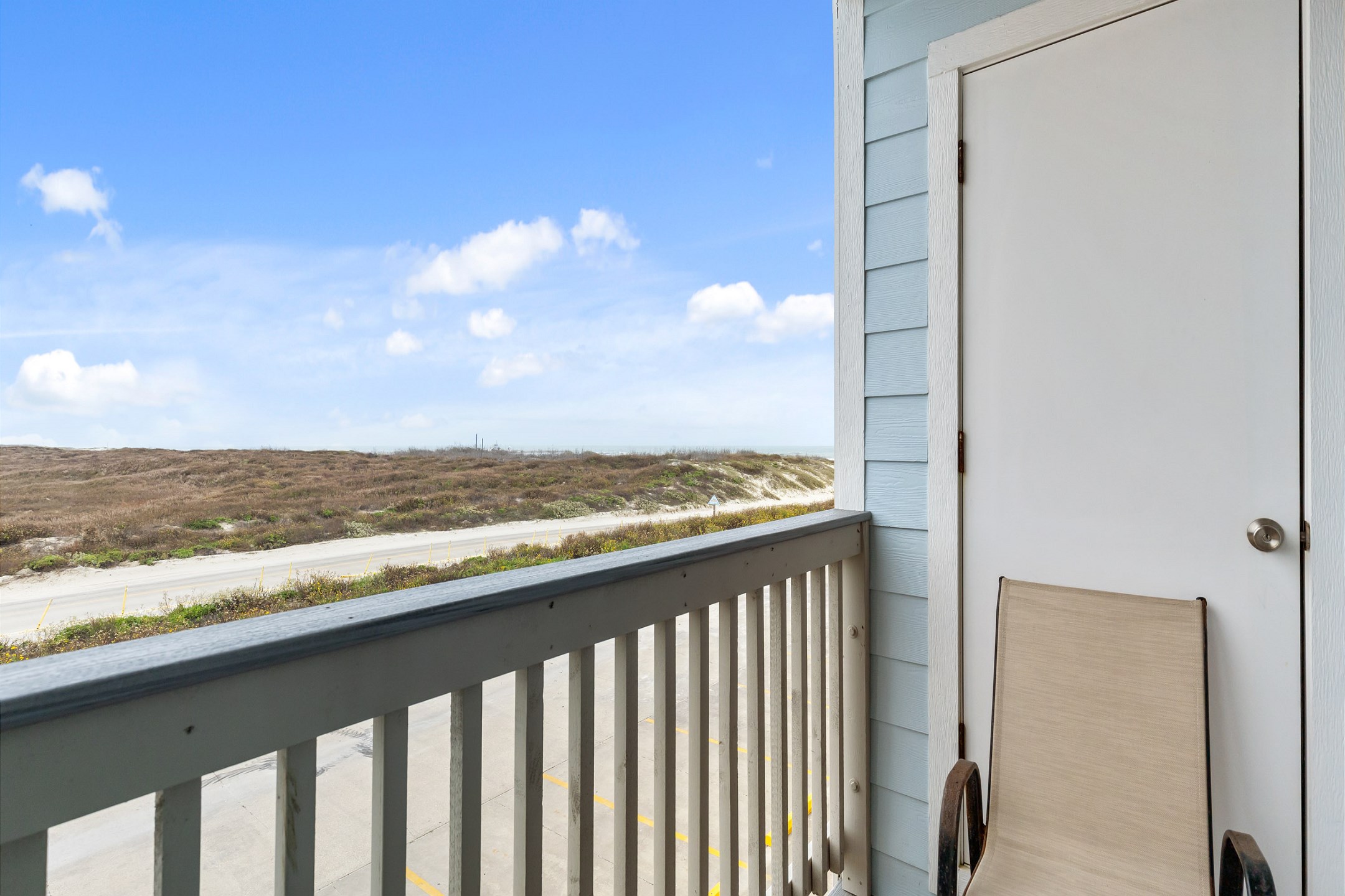 Private balcony off the living space with chairs 