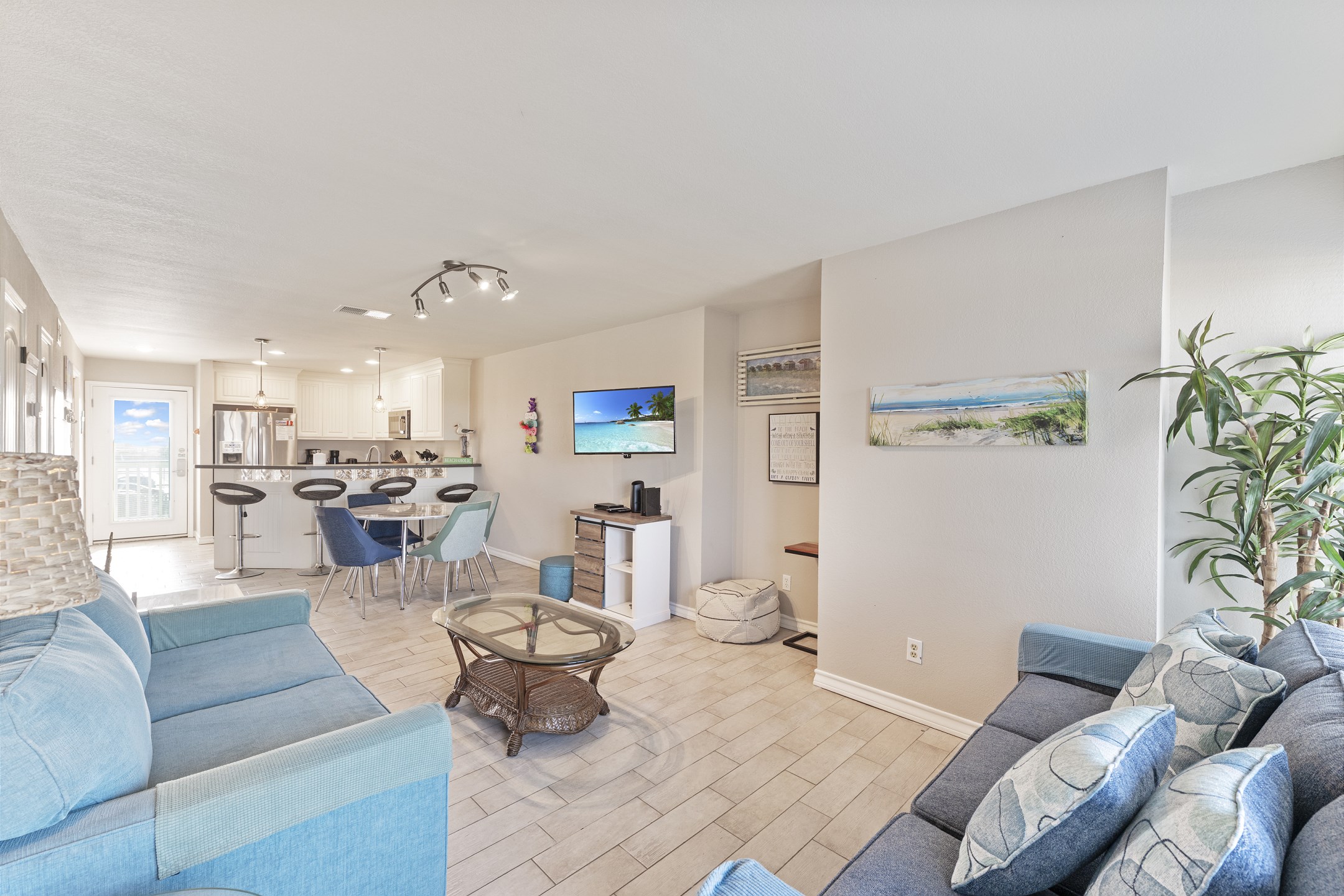 Versatile living area featuring an open layout with a new dining table - ideal for both relaxation and entertaining