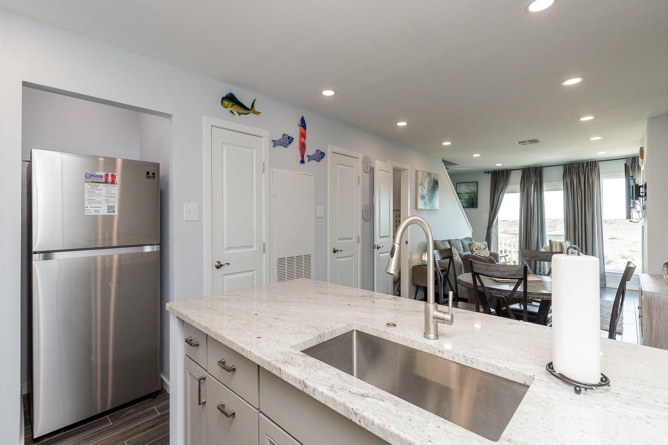 The kitchen, dining, and living areas blend together seamlessly for a bright and airy feel