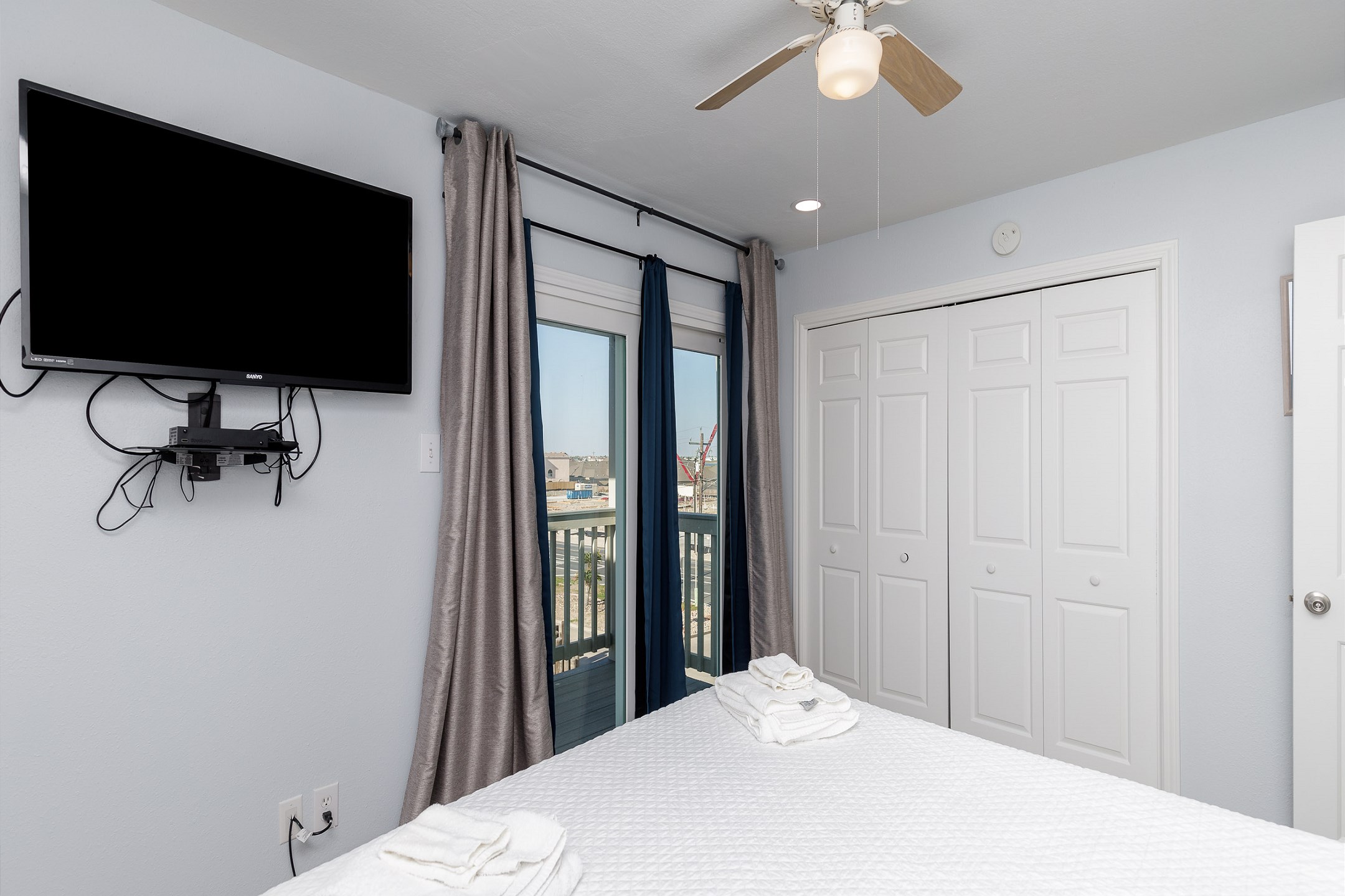 Second bedroom on the second floor with queen size bed, private balcony and flat screen TV