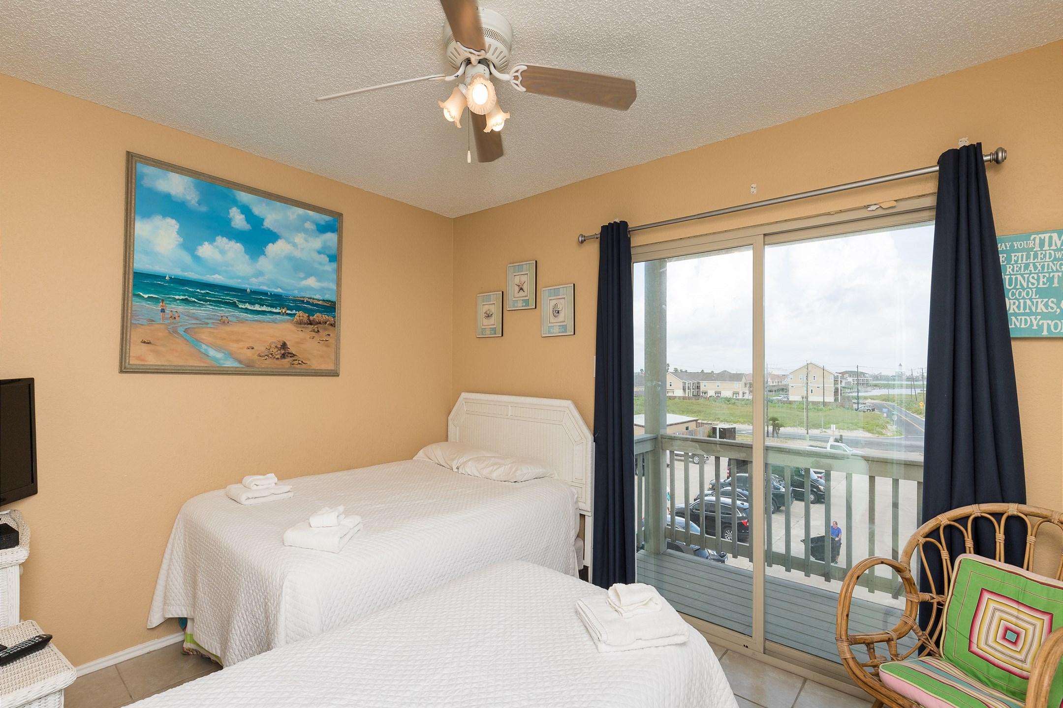 Second bedroom on the second floor with queen and twin size bed, along with flat screen TV and private balcony 