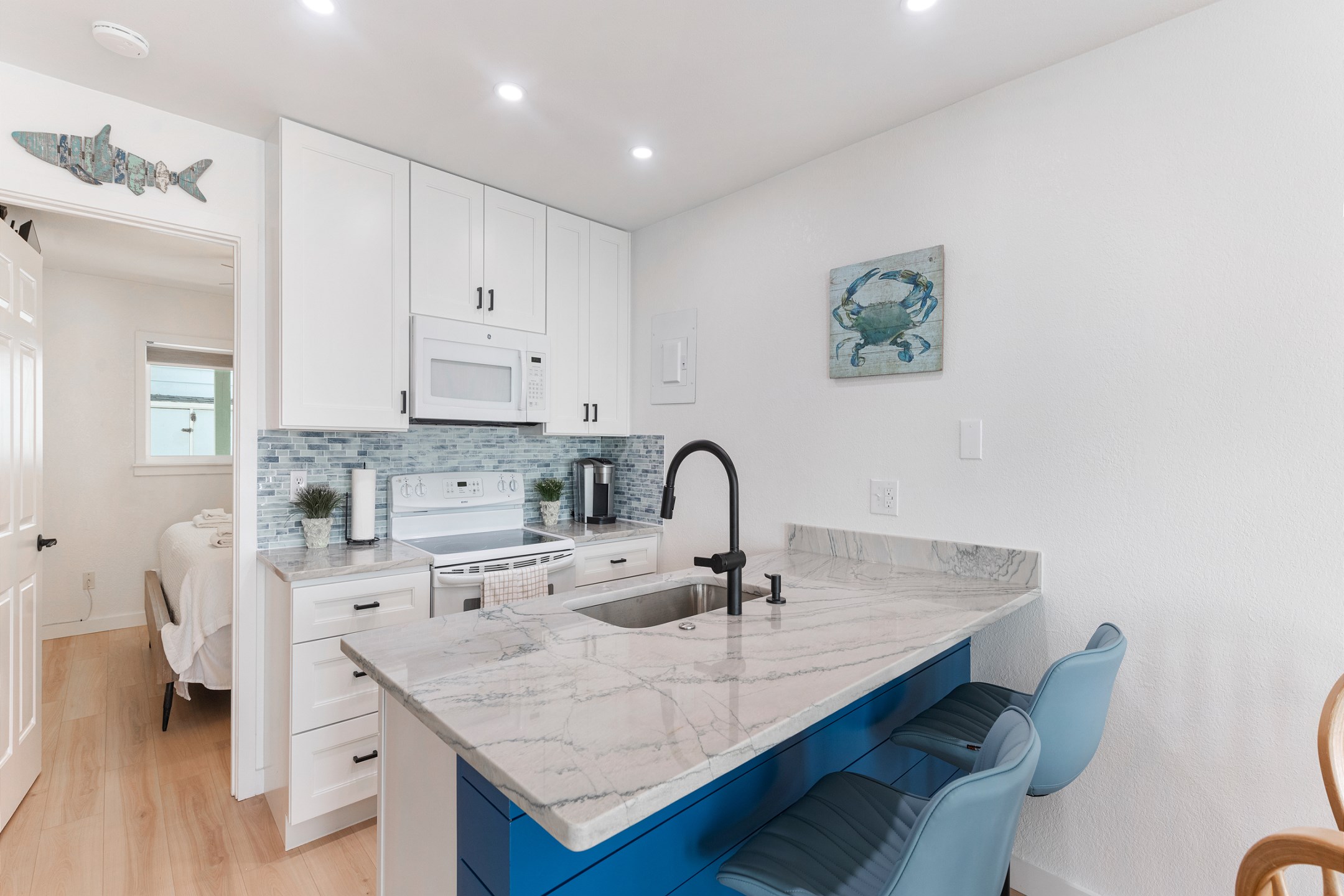 Beautifully updated kitchen space with remodeled counter tops, cabinets and backsplash to cook meals