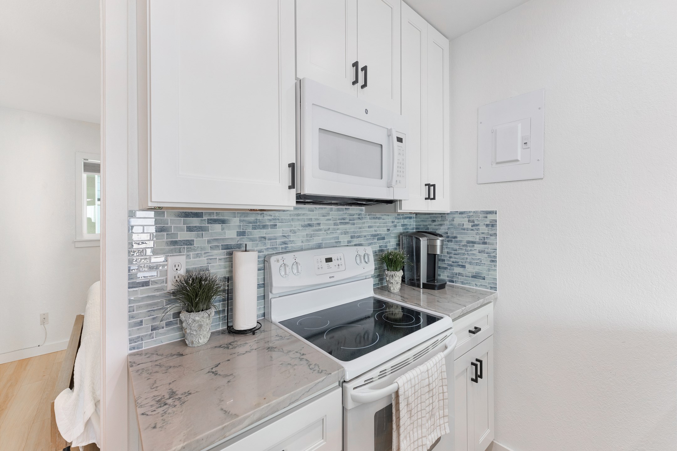 Remodeled kitchen space with new counters, backsplash, cabinets and fresh paint with everything you need to entertain guests