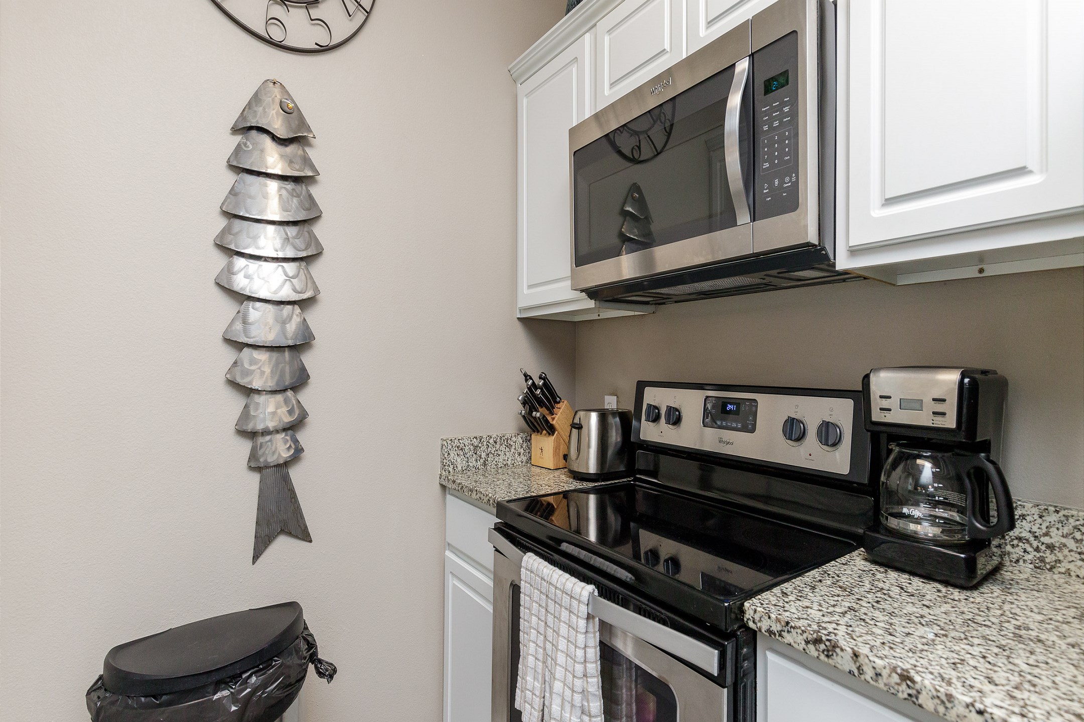 Kitchen area with coffee maker, toaster, cookware, dinnerware, and other kitchen essentials provided