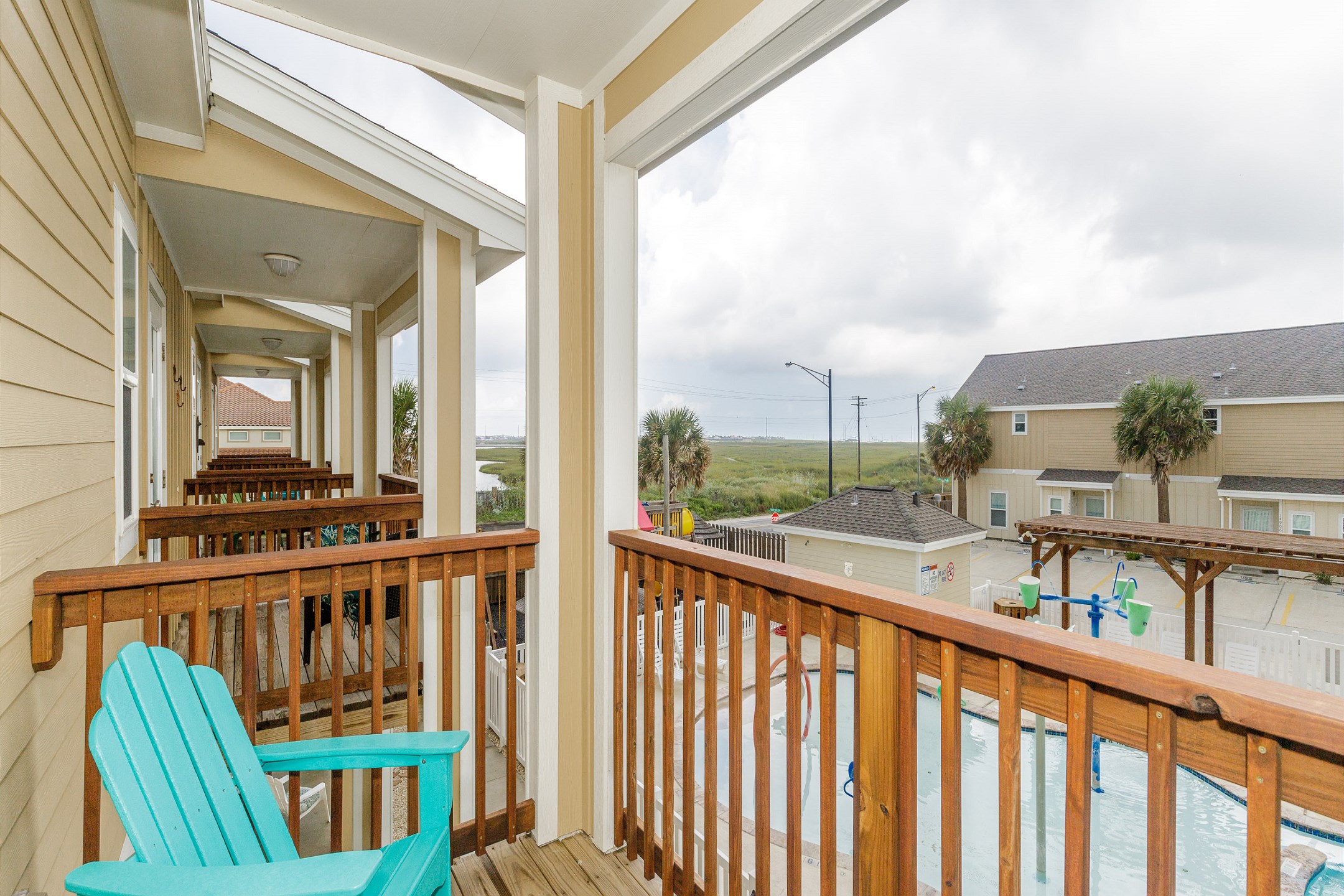Private balcony off of master bedroom with a view of the pool