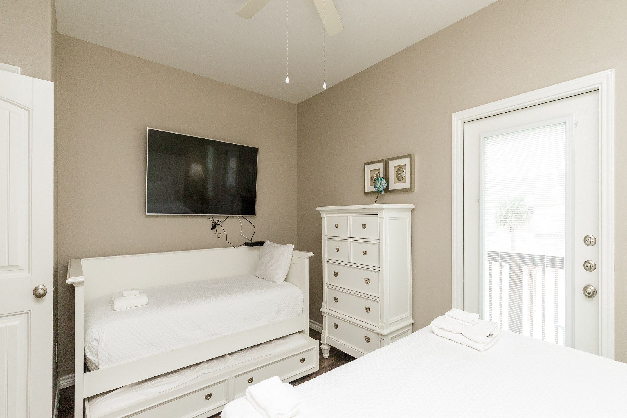 Master bedroom on the second floor with king size bed, twin size day bed, twin trundle, private balcony, private bathroom and flat screen TV