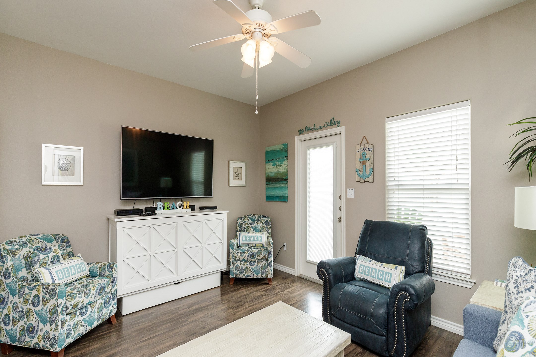 Modern entertainment haven boasting a state-of-the-art flat-screen TV and comfortable lounging options for movie nights