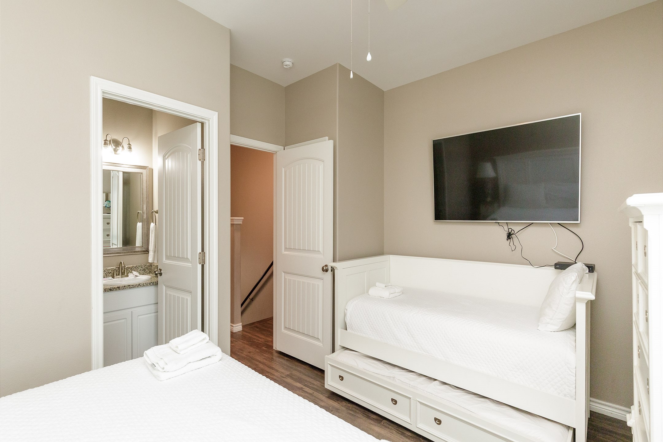 Master bedroom on the second floor with king size bed, twin size day bed, twin trundle, private balcony, private bathroom and flat screen TV