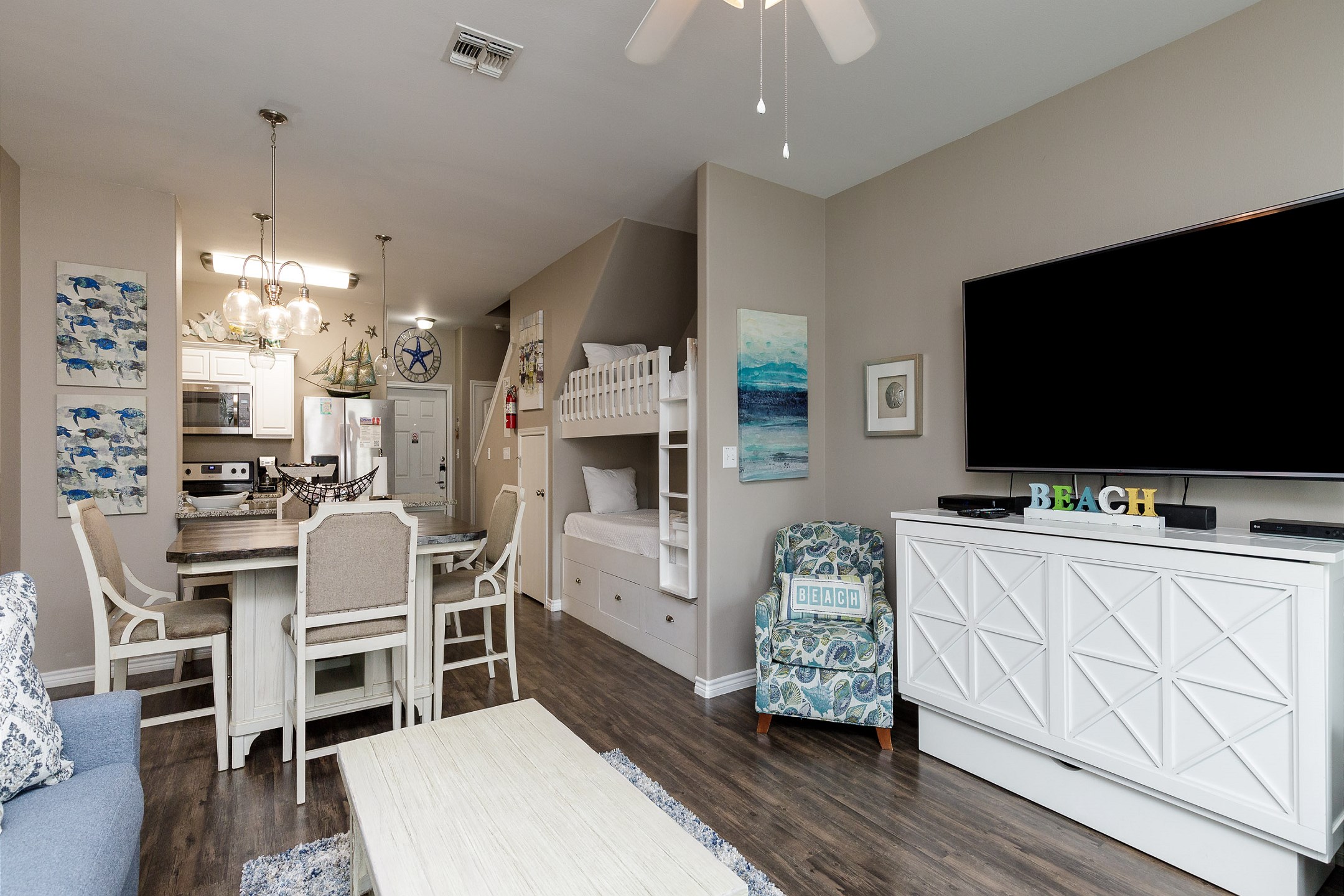 Open concept living area with queen size credenza bed and coastal features through out 