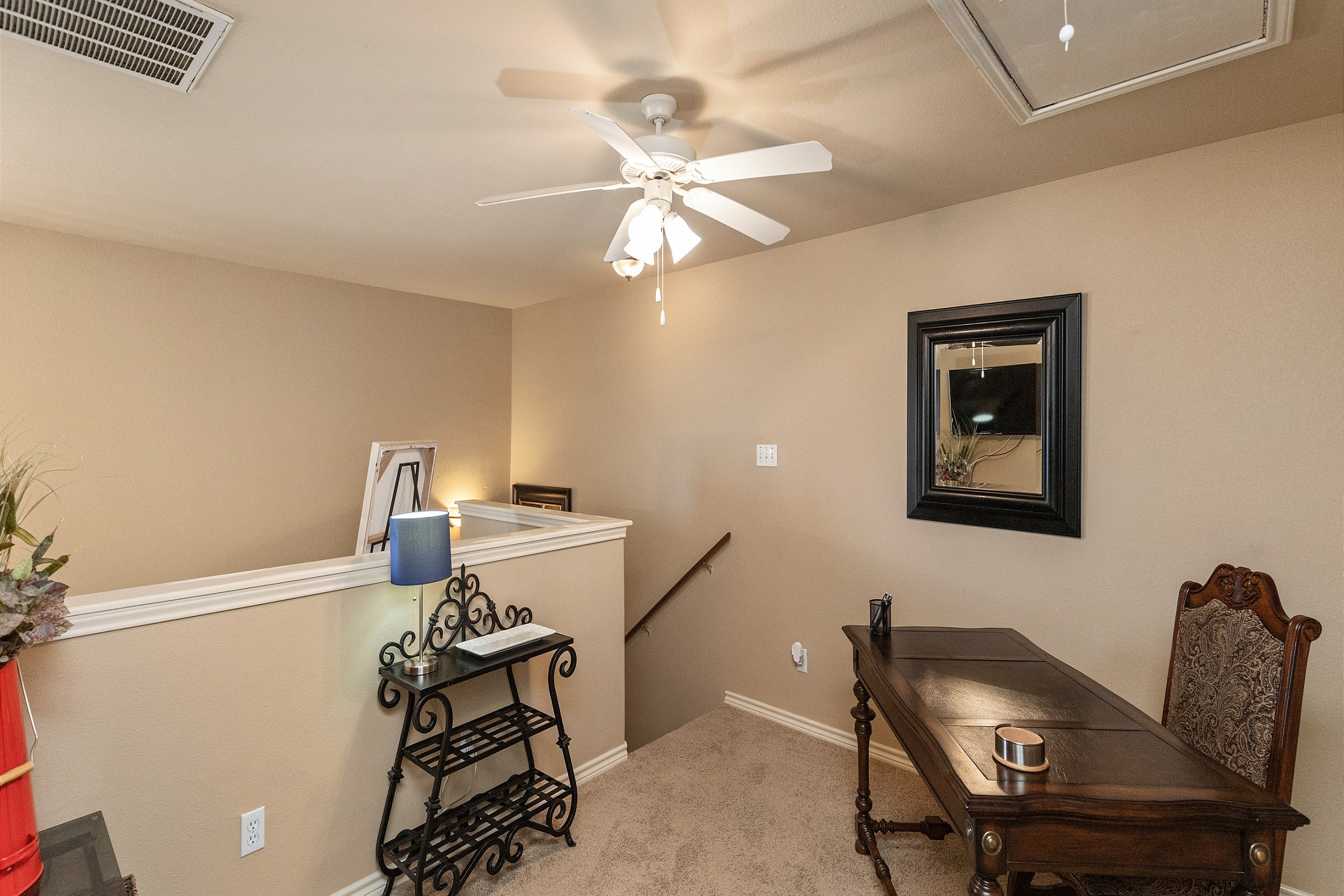 Second floor loft/second living area with a large desk and flat screen TV