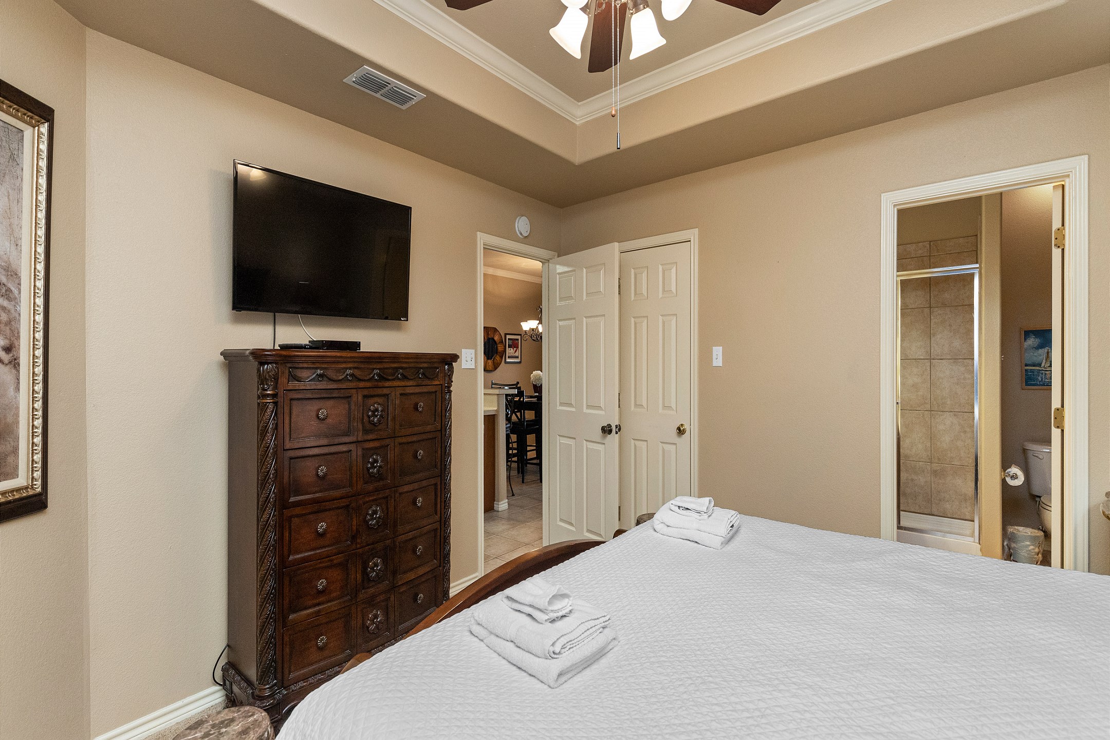 First floor master bedroom with king size bed, ensuite bathroom, and TV