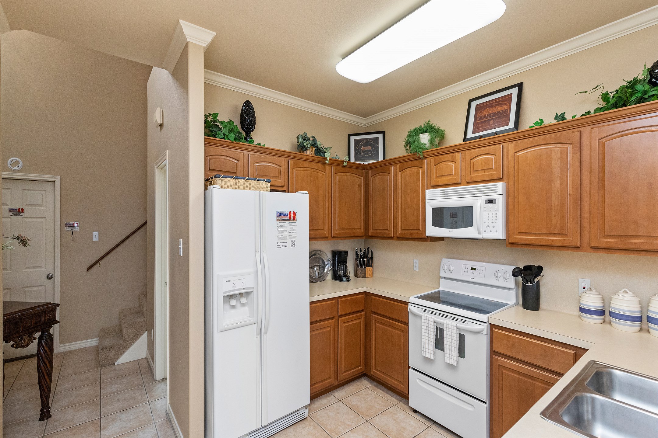 Coffee maker, toaster, cookware, dinnerware, and other kitchen essentials provided