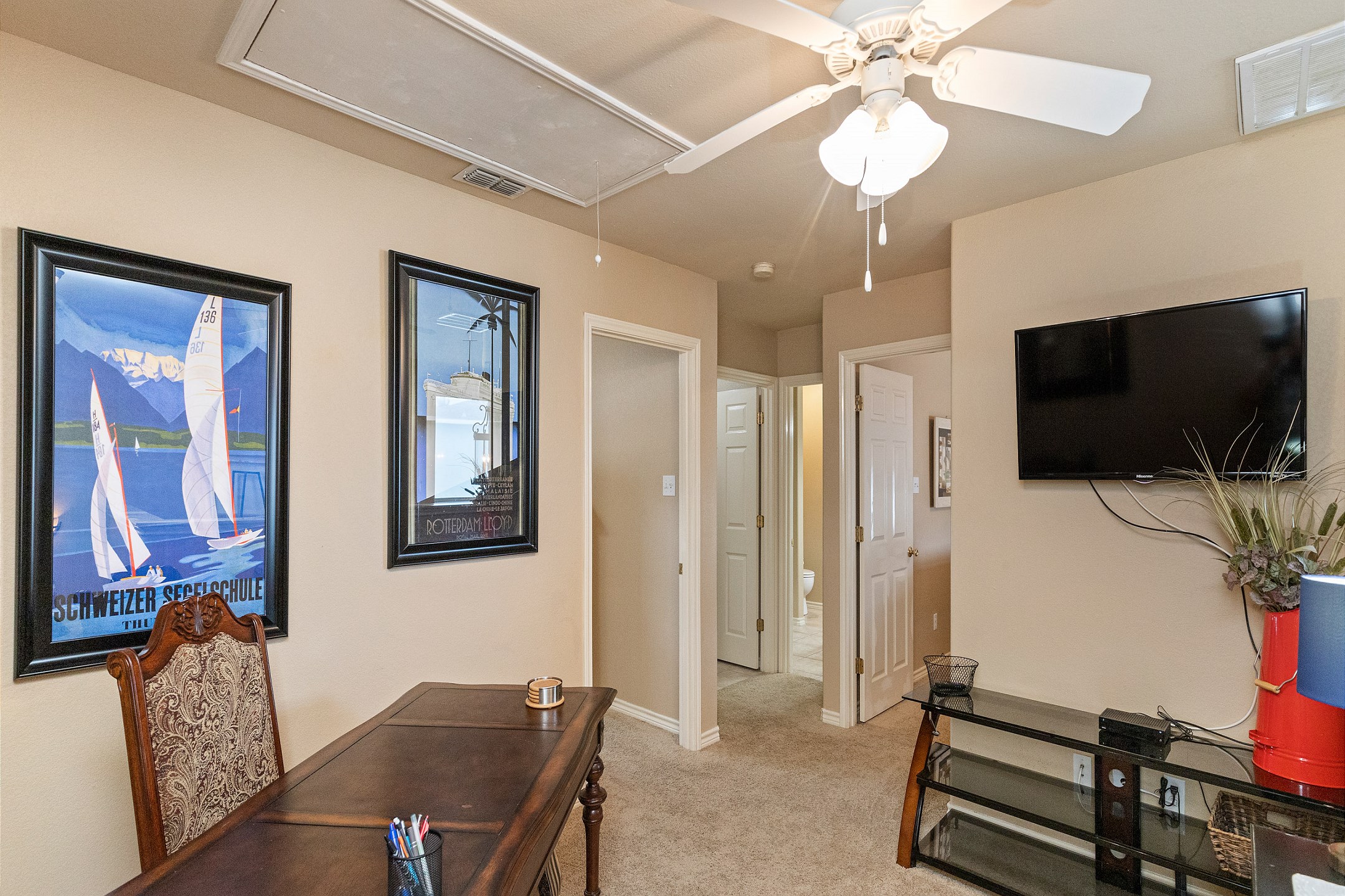 Second floor loft/second living area with a large desk and flat screen TV