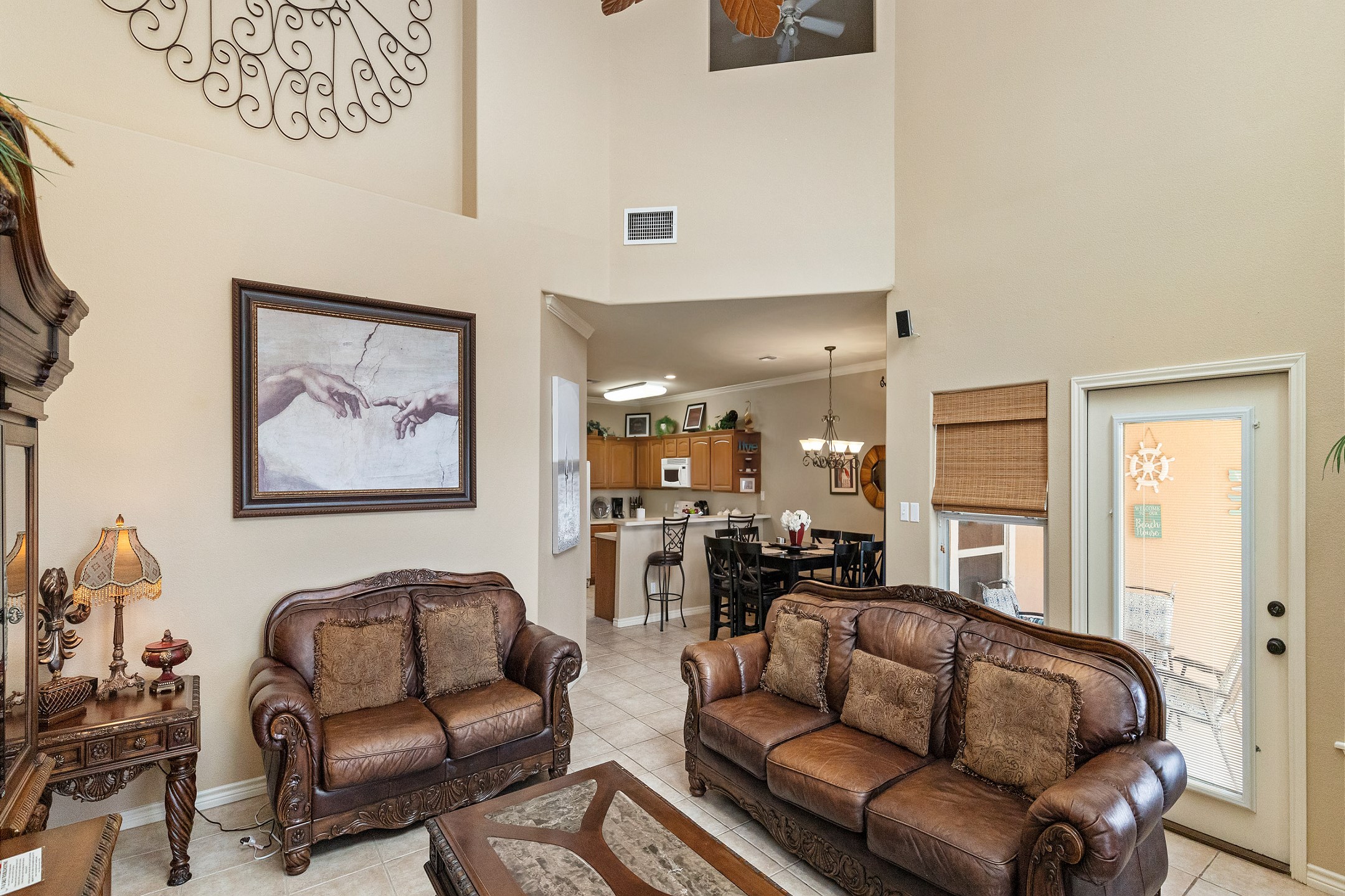Spacious living area with high ceilings and filled with natural light