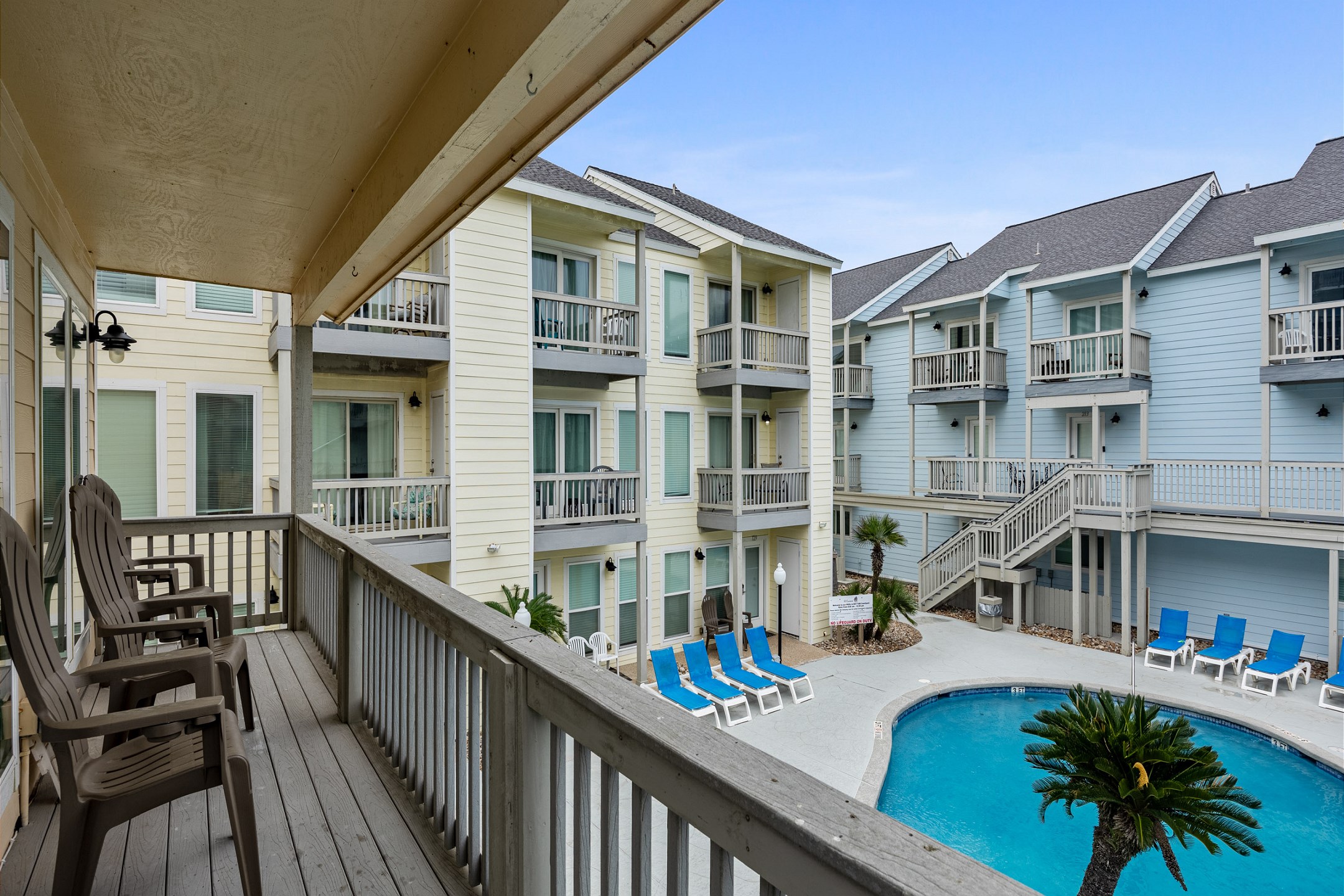 Pool-view private balcony with seating outside the living area