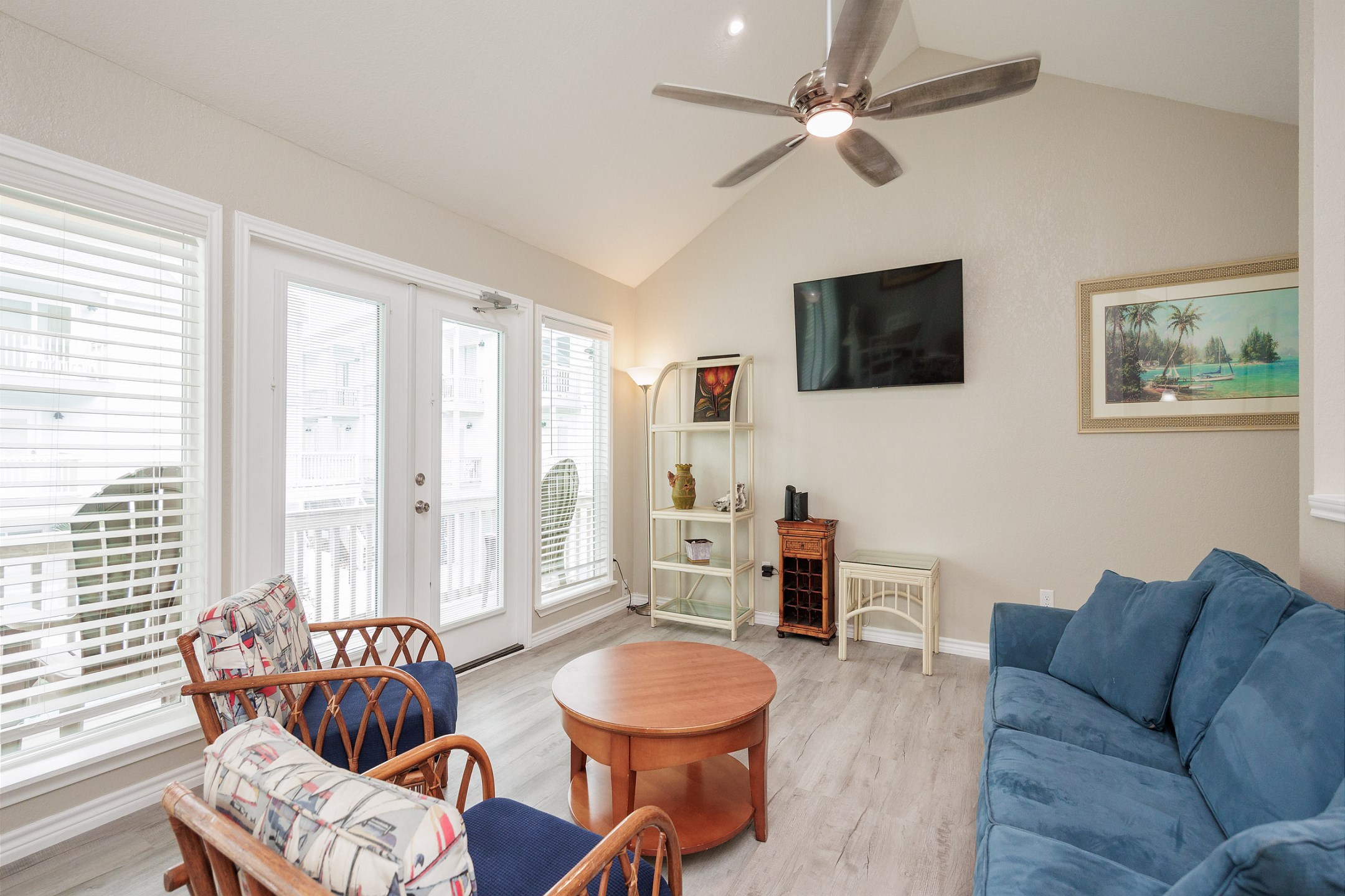 Charming living area with flat screen TV and lots of natural lighting