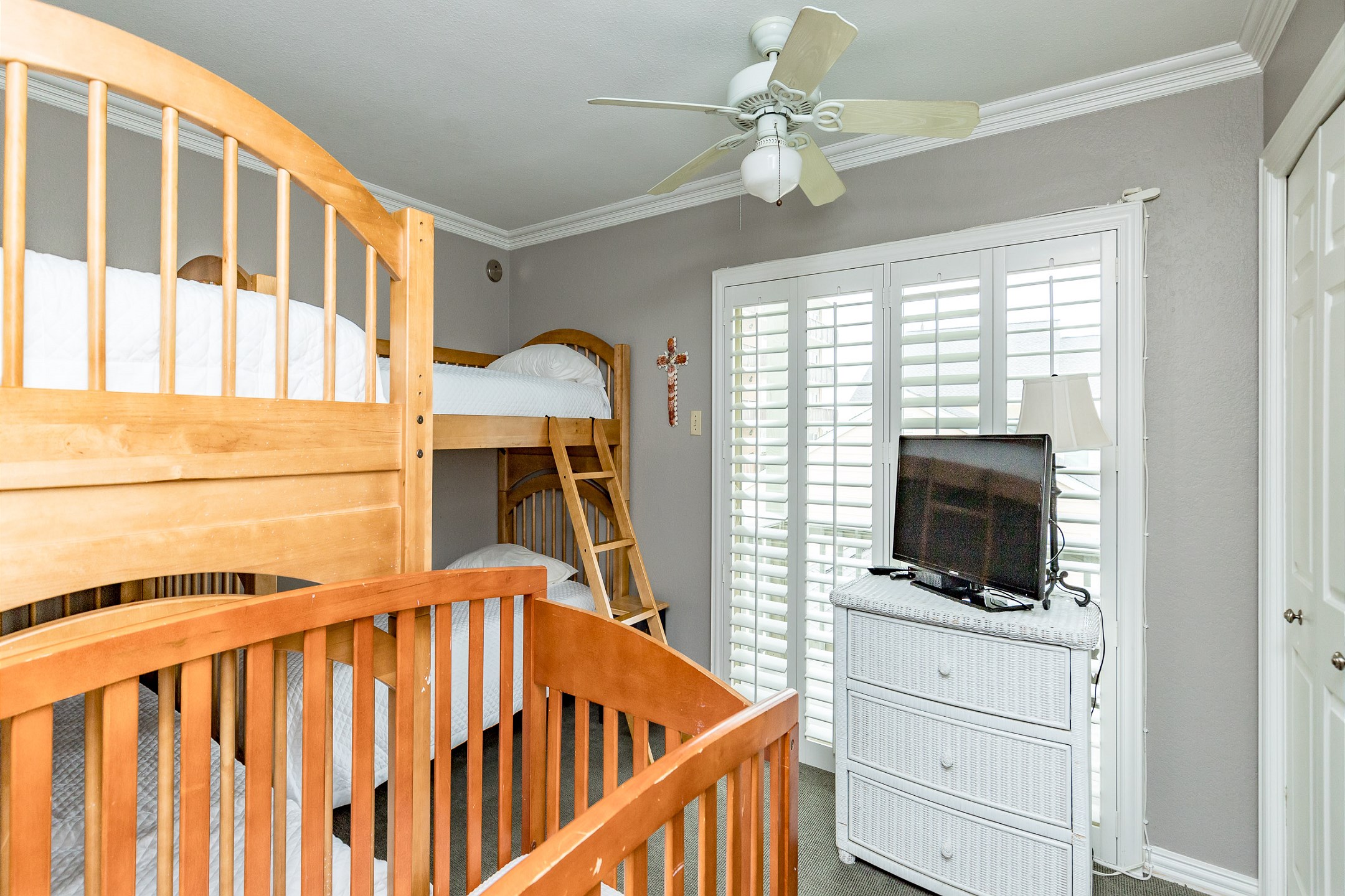 Second bedroom on the second floor with two sets of twin size bunk beds and a crib (sheets not provided for crib), along with flat screen TV and private balcony 